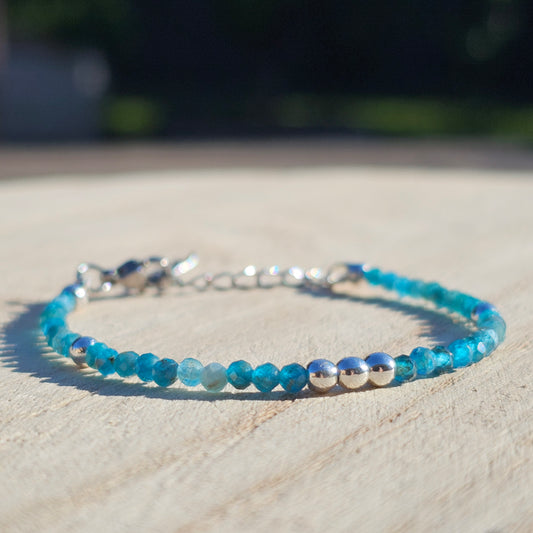 Delicate, faceted dainty AA grade Blue Apatite and AAA grade silver plated Hematite bead bracelet with a silver stainless steel clasp and extender chain.