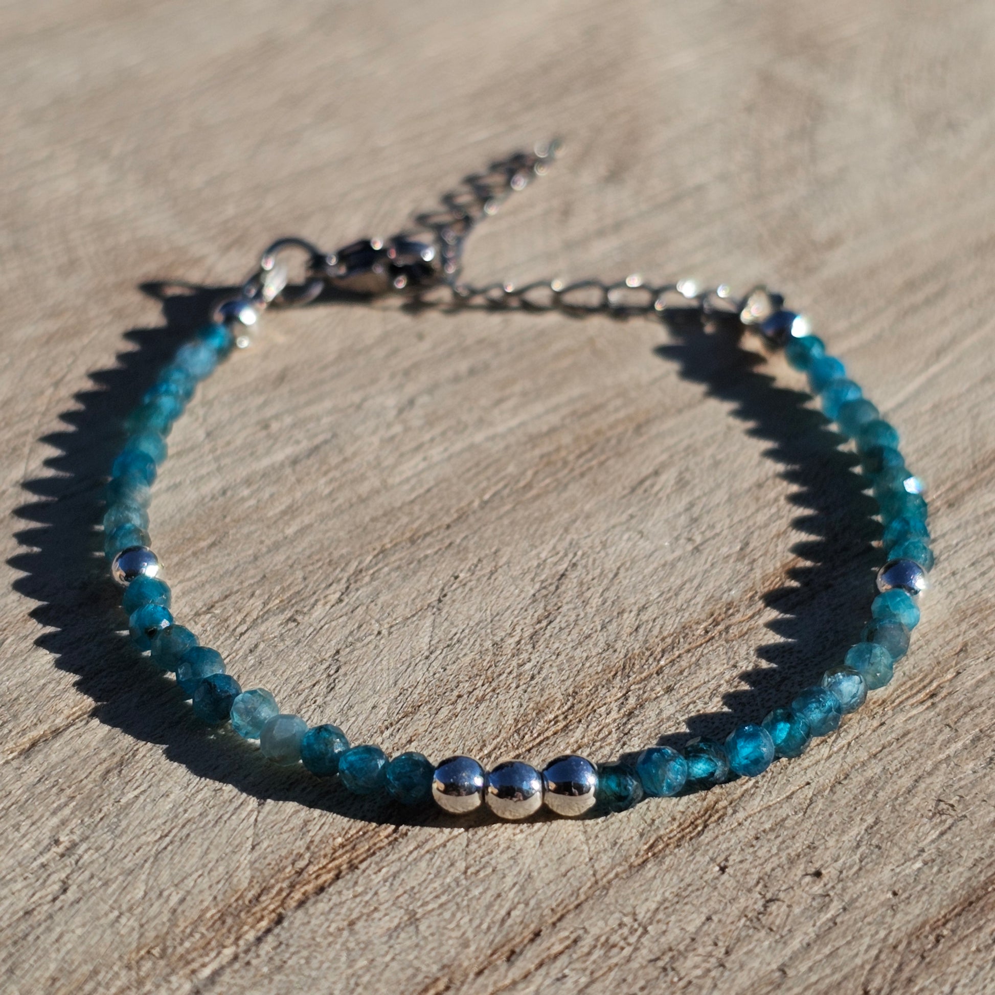 Delicate, faceted dainty AA grade Blue Apatite and AAA grade silver plated Hematite bead bracelet with a silver stainless steel clasp and extender chain.