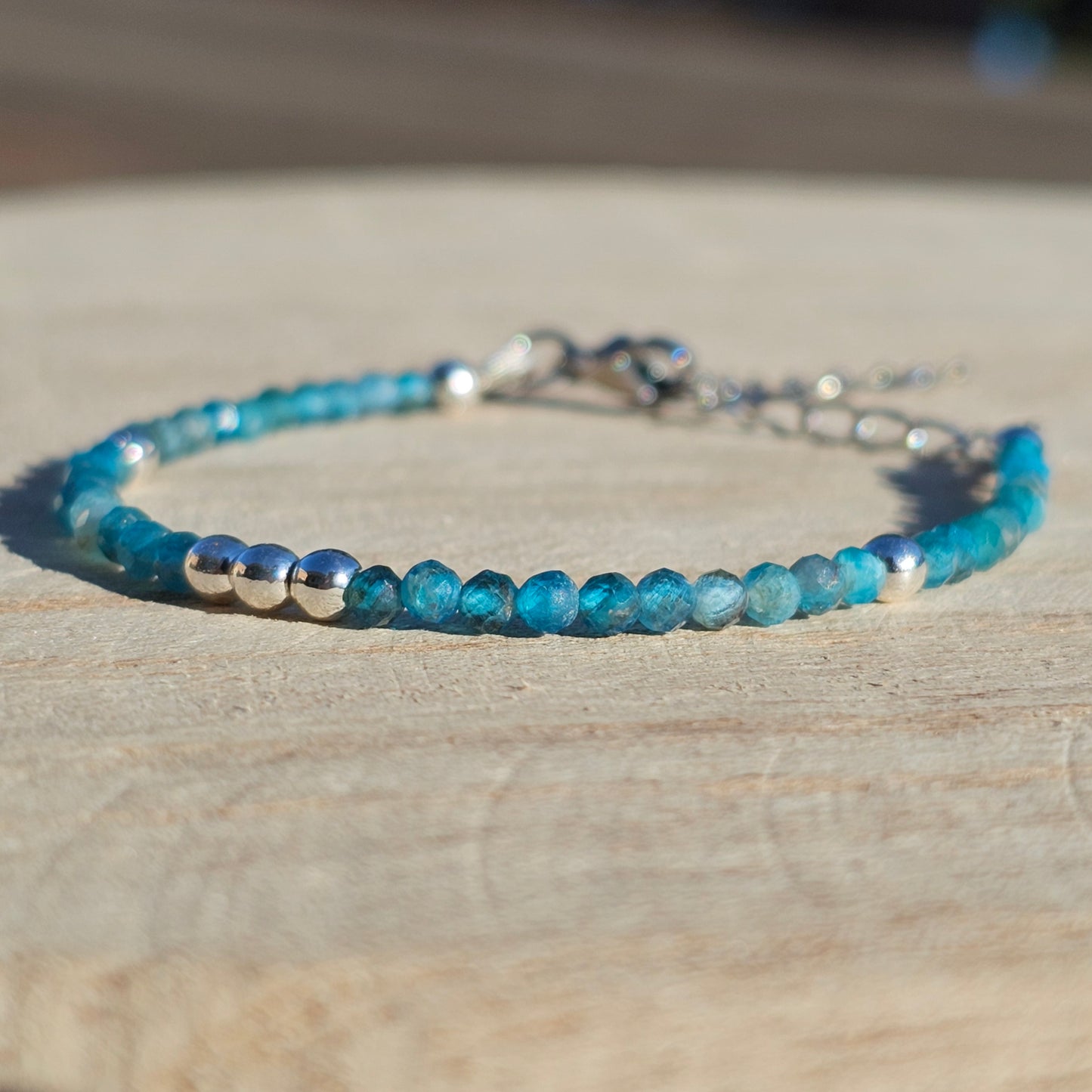 Delicate, faceted dainty AA grade Blue Apatite and AAA grade silver plated Hematite bead bracelet with a silver stainless steel clasp and extender chain.