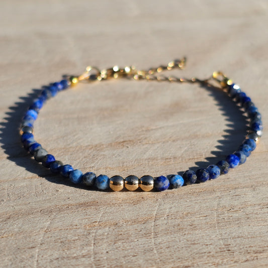 Delicate, faceted dainty AA grade Lapis Lazuli and AAA grade gold plated Hematite bead bracelet with a gold stainless steel clasp and extender chain.