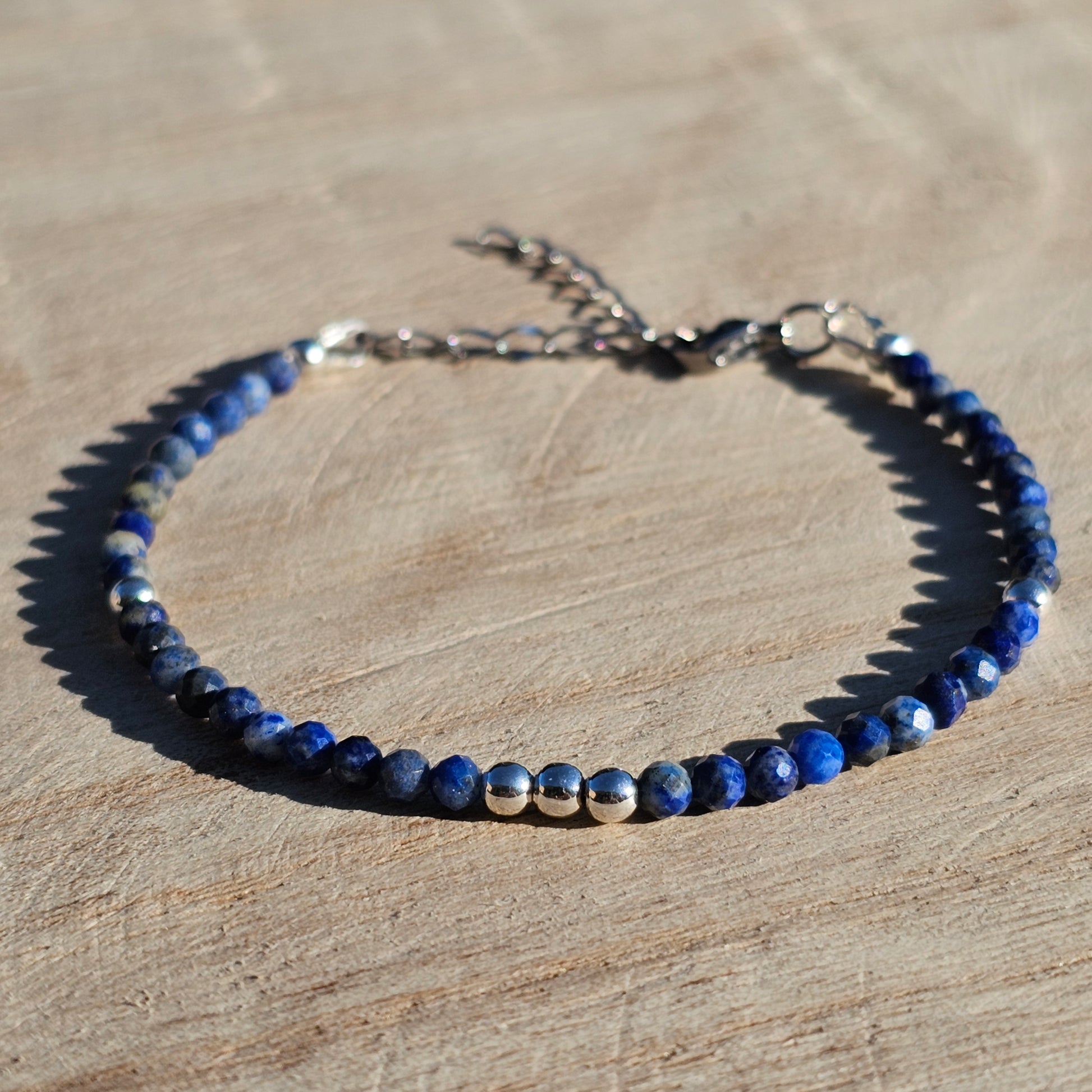 Delicate, faceted dainty AA grade Lapis Lazuli and AAA grade silver plated Hematite bead bracelet with a silver stainless steel clasp and extender chain.