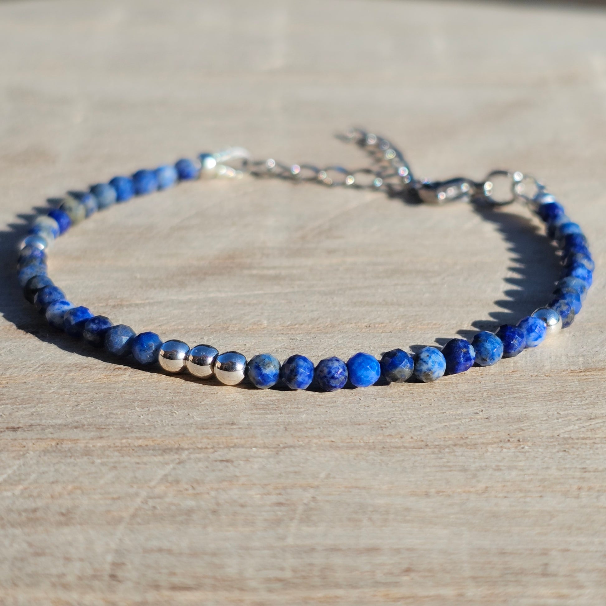 Delicate, faceted dainty AA grade Lapis Lazuli and AAA grade silver plated Hematite bead bracelet with a silver stainless steel clasp and extender chain.