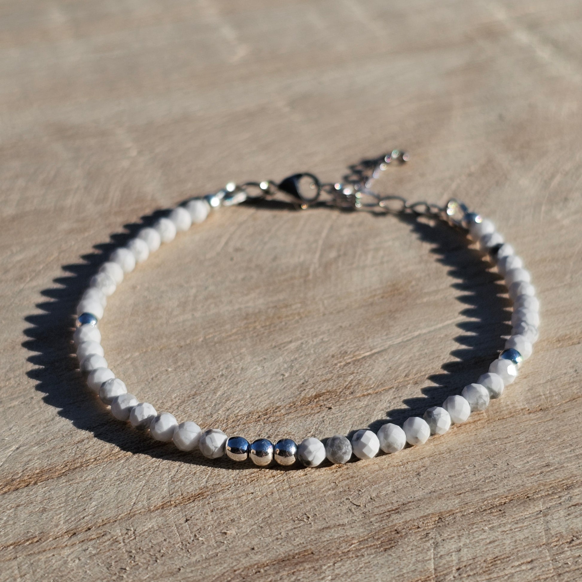 Delicate, faceted dainty AA grade Howlite and AAA grade silver plated Hematite bead bracelet with a silver stainless steel clasp and extender chain.