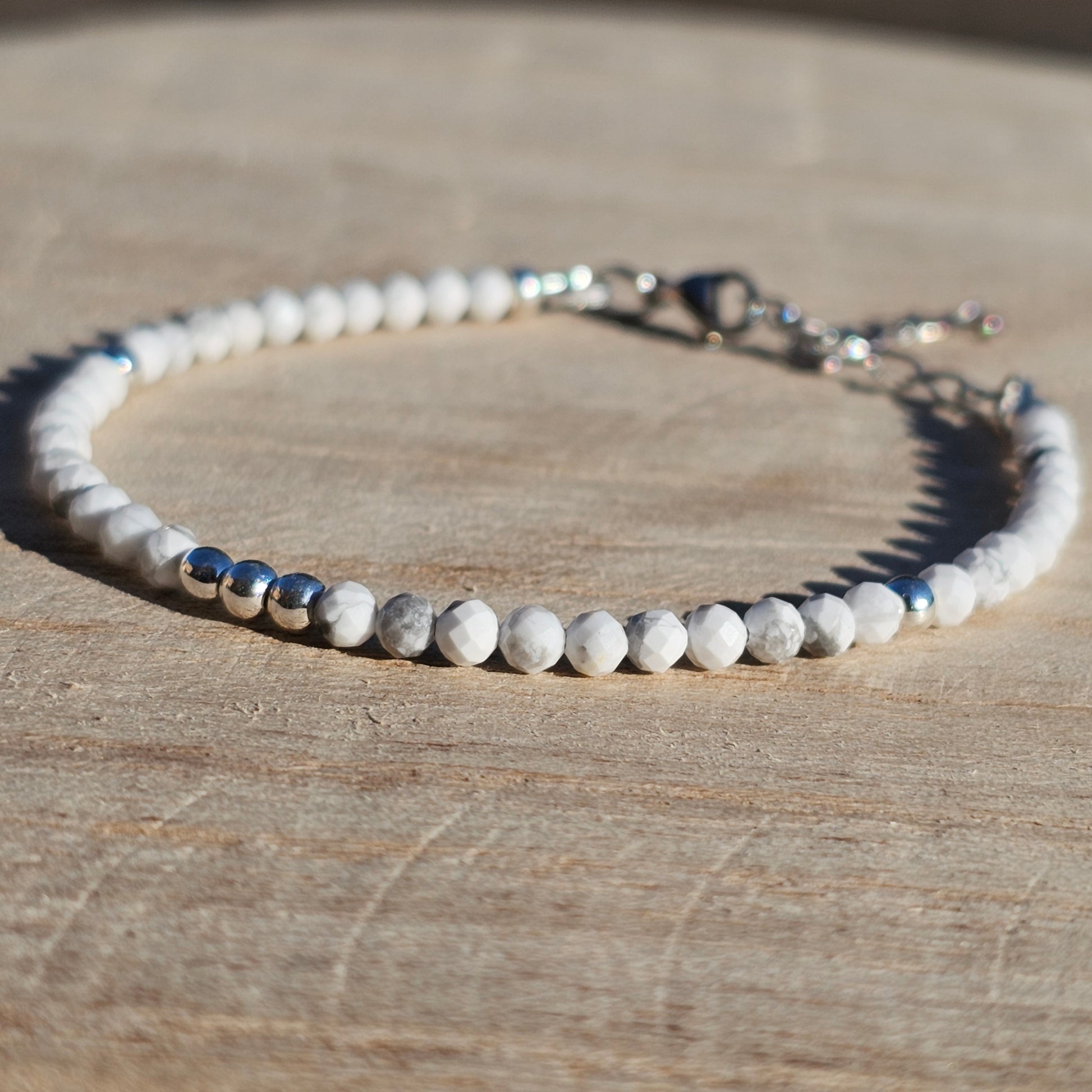 Delicate, faceted dainty AA grade Howlite and AAA grade silver plated Hematite bead bracelet with a silver stainless steel clasp and extender chain.