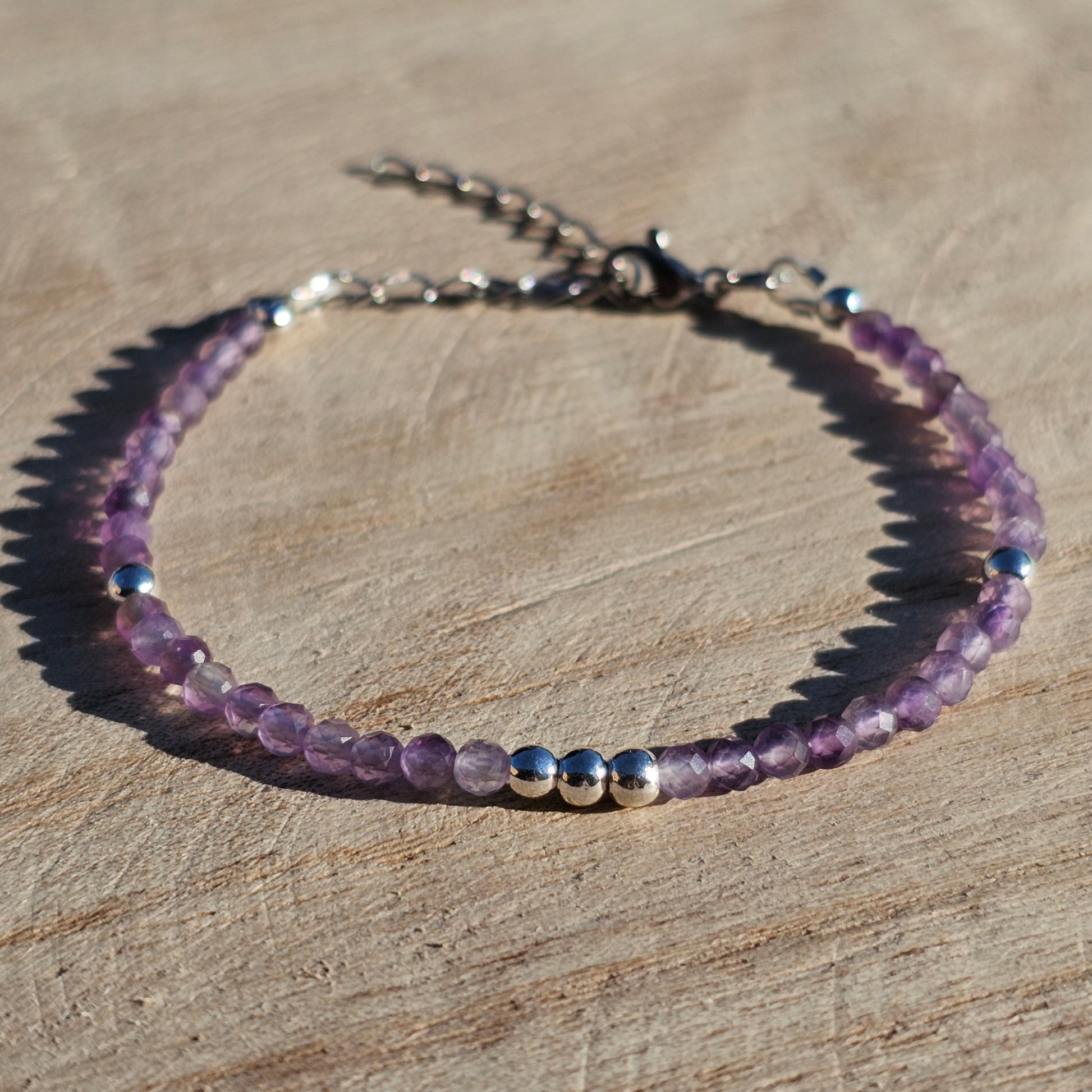 Delicate, faceted dainty AA grade Amethyst and AAA grade silver plated Hematite bead bracelet with a silver stainless steel clasp and extender chain.