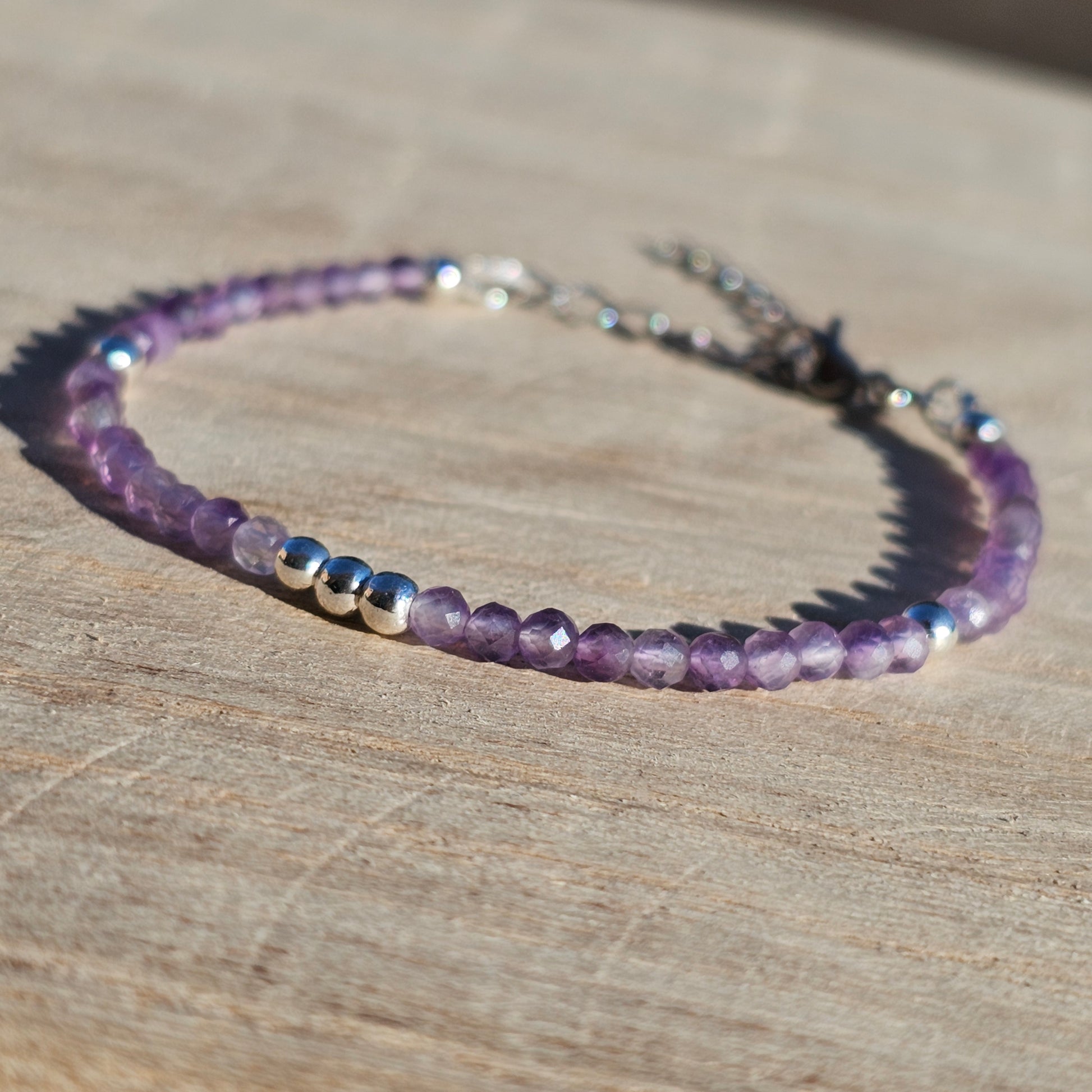 Delicate, faceted dainty AA grade Amethyst and AAA grade silver plated Hematite bead bracelet with a silver stainless steel clasp and extender chain.