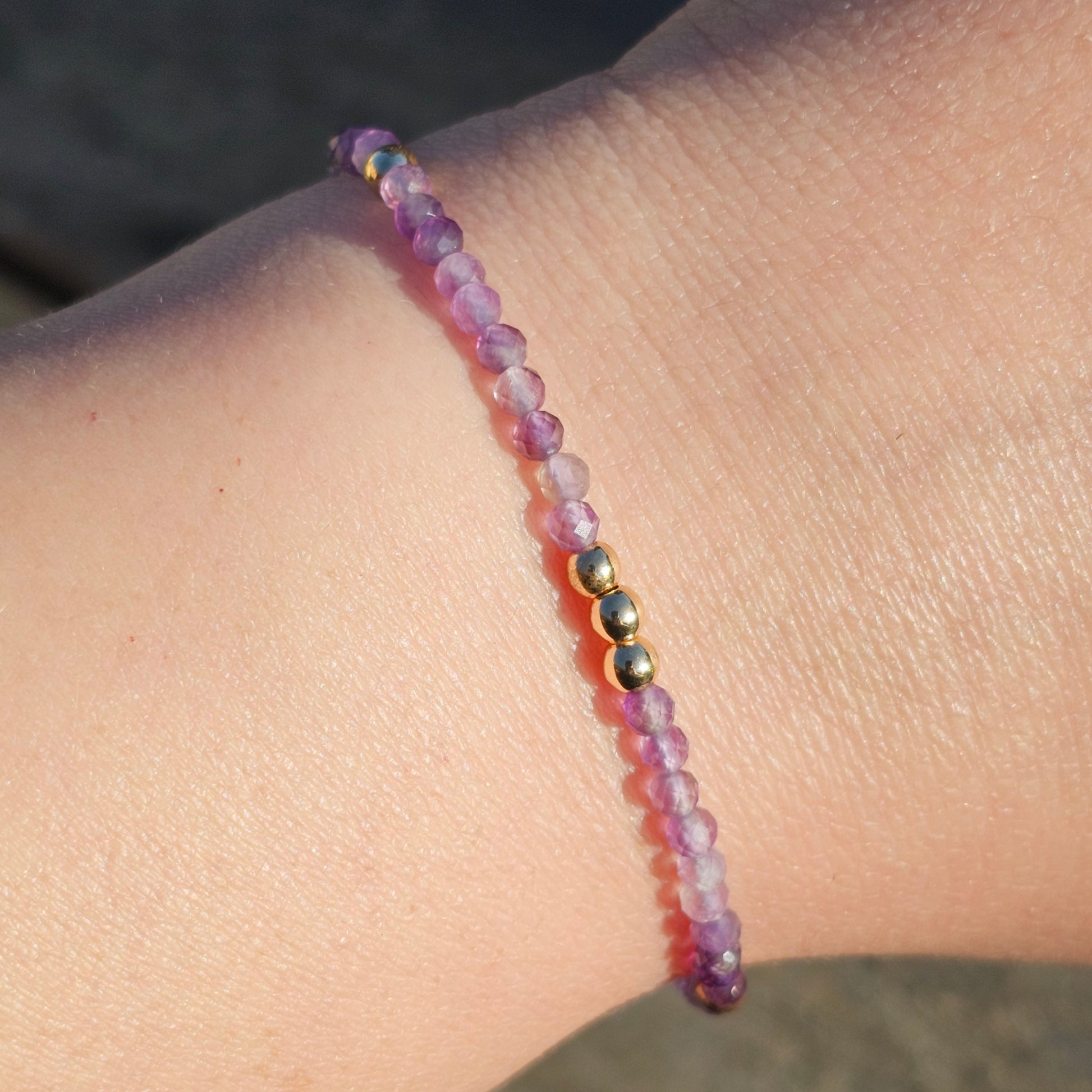 Delicate, faceted dainty AA grade Amethyst and AAA grade gold plated Hematite bead bracelet with a gold stainless steel clasp and extender chain.