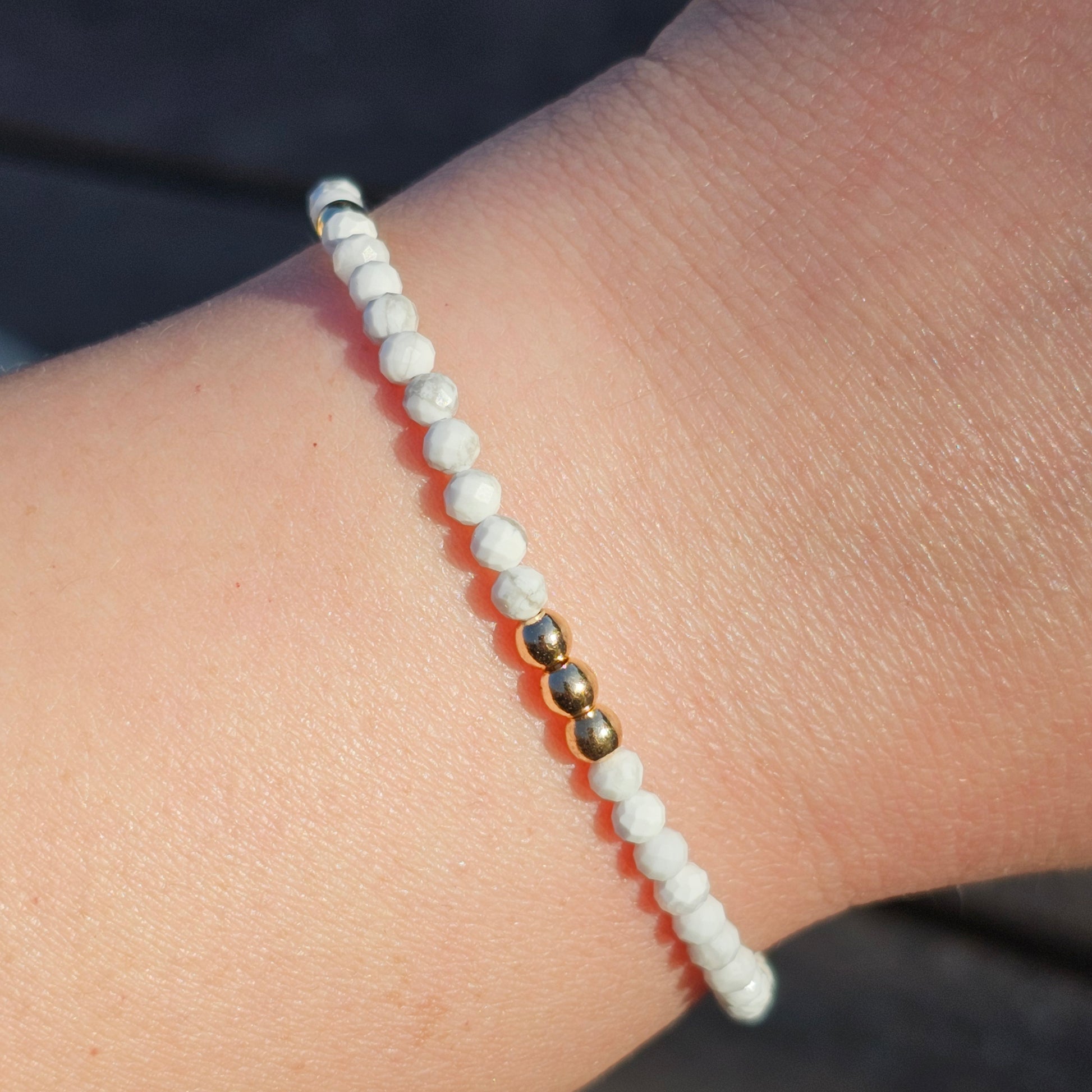 Delicate, faceted dainty AA grade Howlite and AAA grade gold plated Hematite bead bracelet with a gold stainless steel clasp and extender chain.