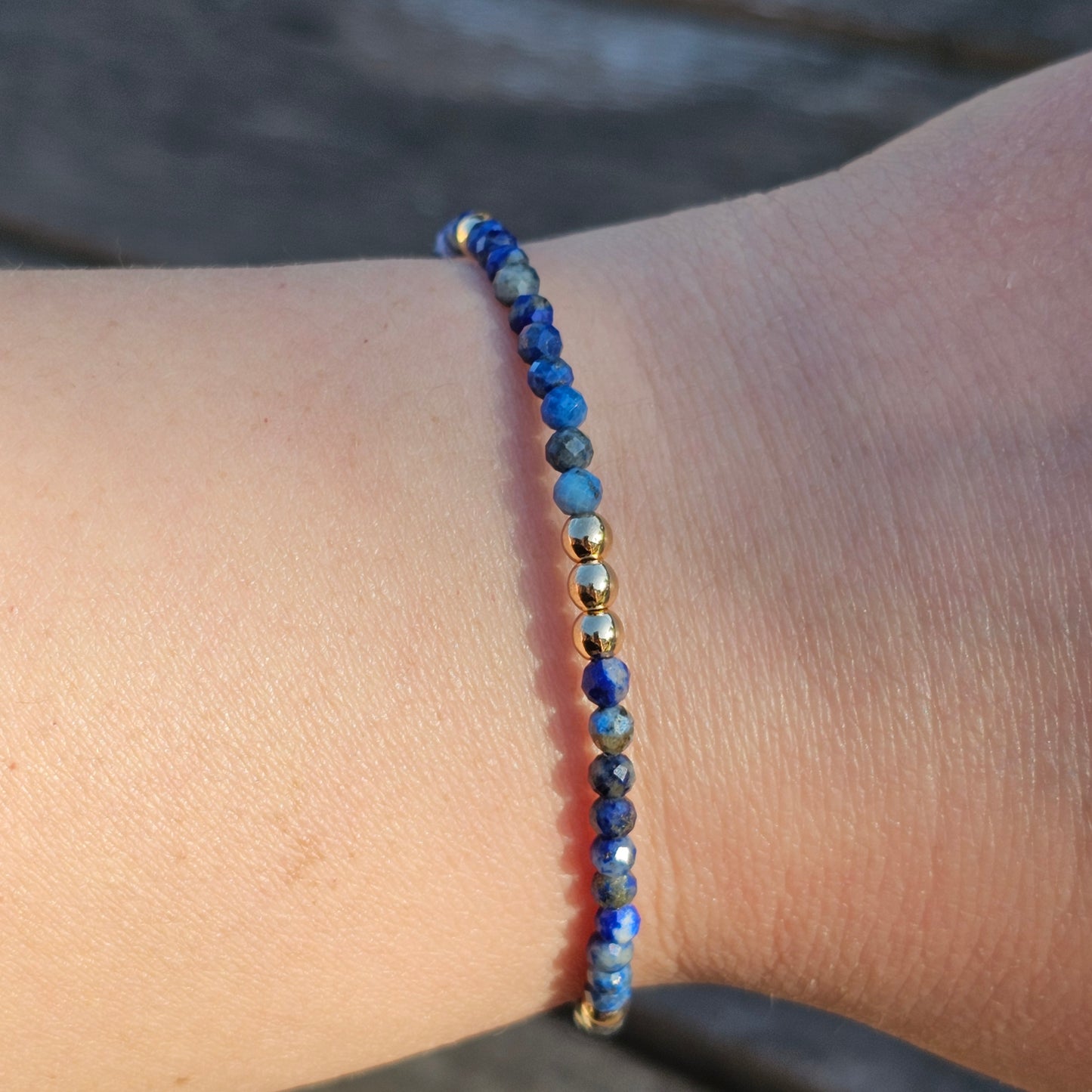 Delicate, faceted dainty AA grade Lapis Lazuli and AAA grade gold plated Hematite bead bracelet with a gold stainless steel clasp and extender chain.