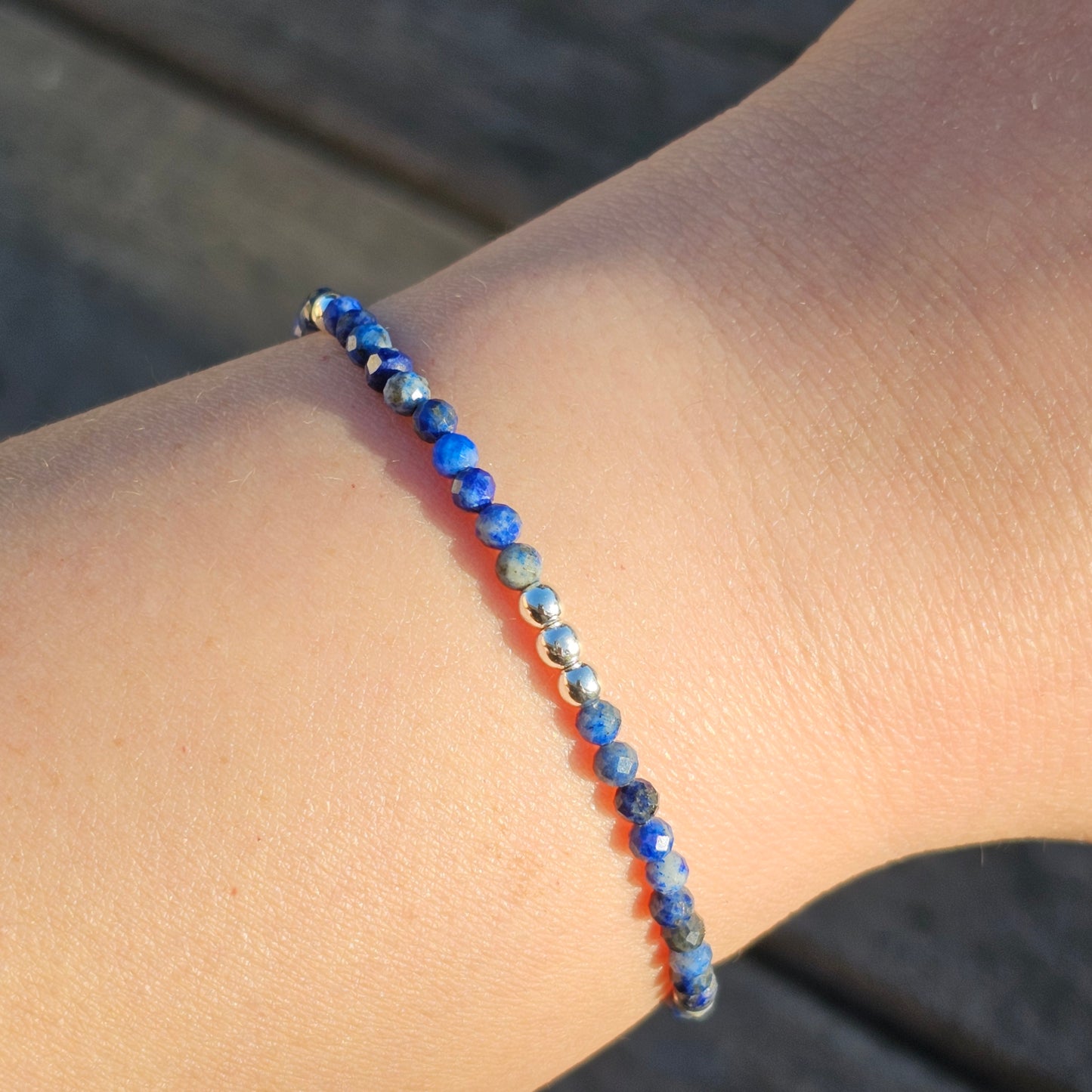 Delicate, faceted dainty AA grade Lapis Lazuli and AAA grade silver plated Hematite bead bracelet with a silver stainless steel clasp and extender chain.