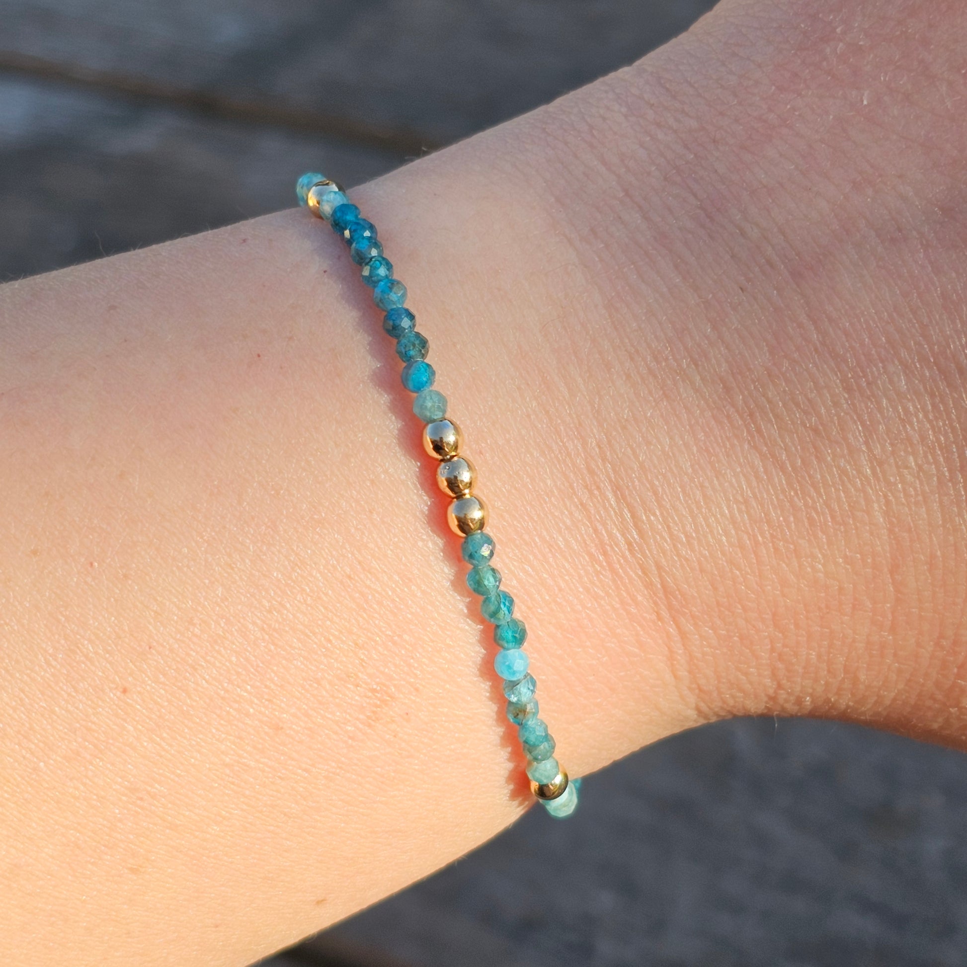 Delicate, faceted dainty AA grade Blue Apatite and AAA grade gold plated Hematite bead bracelet with a gold stainless steel clasp and extender chain.