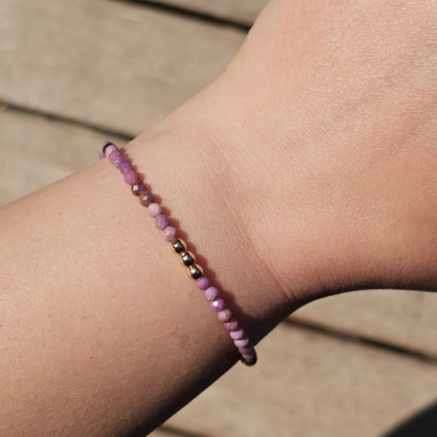 Delicate, faceted dainty Lavender Lepidolite and AAA grade gold plated Hematite bead bracelet with a gold stainless steel clasp and extender chain.