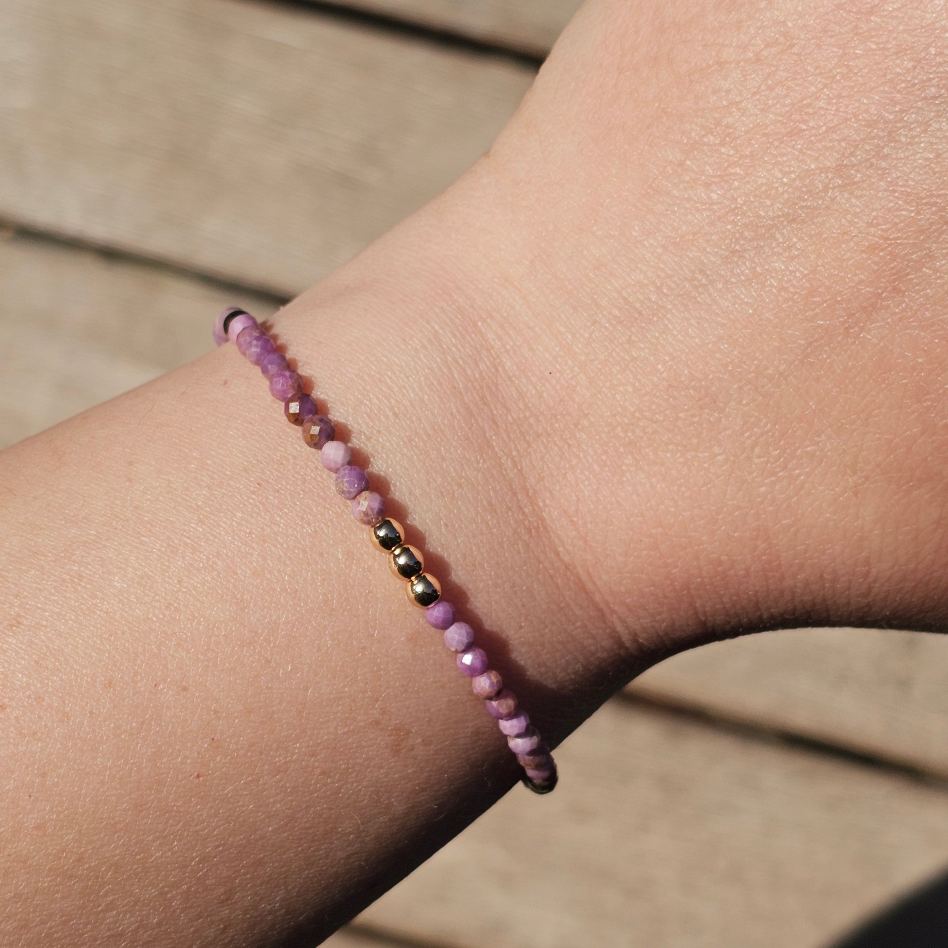 Delicate, faceted dainty Lavender Lepidolite and AAA grade gold plated Hematite bead bracelet with a gold stainless steel clasp and extender chain.