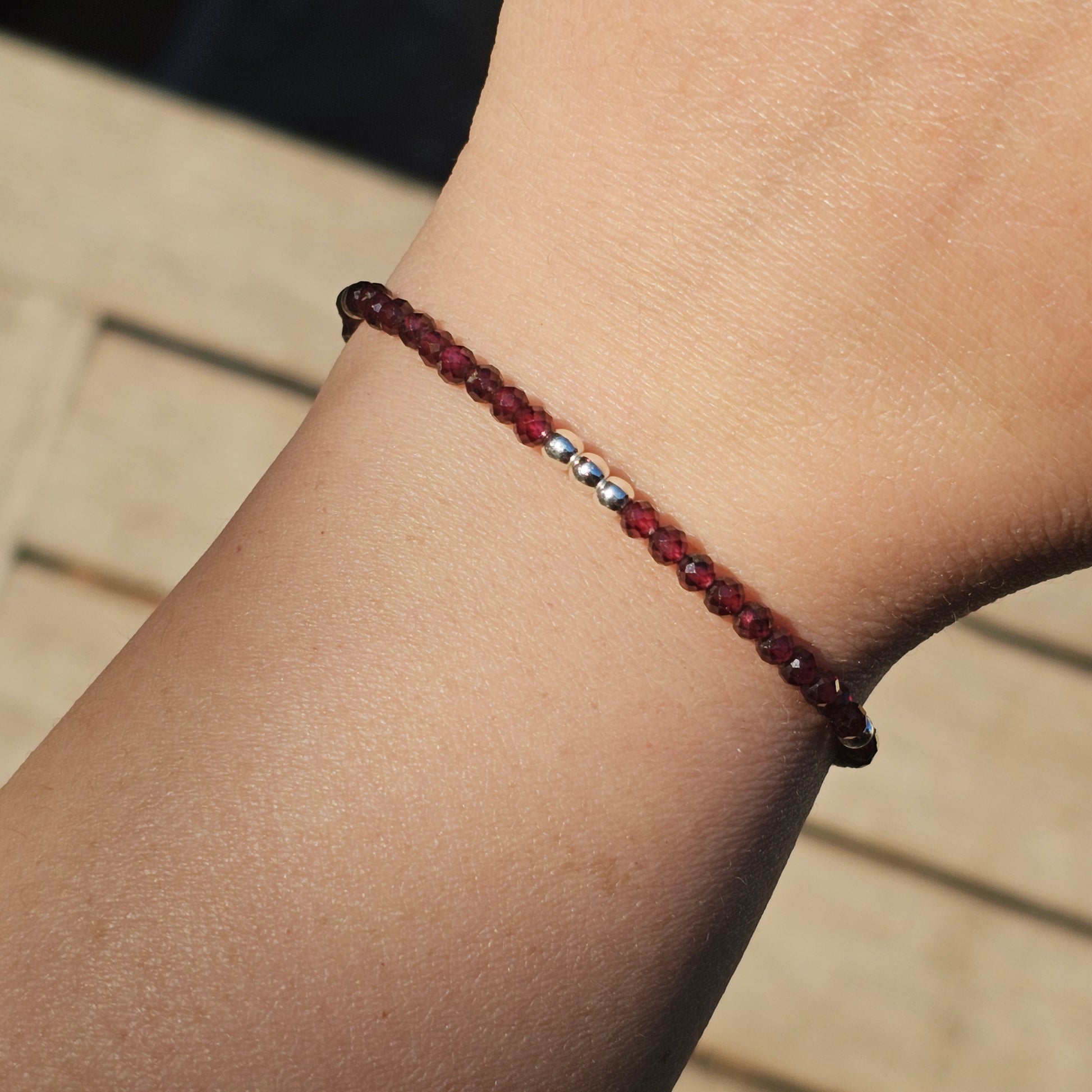 Delicate, faceted dainty AA grade Garnet and AAA grade silver plated Hematite bead bracelet with a silver stainless steel clasp and extender chain.