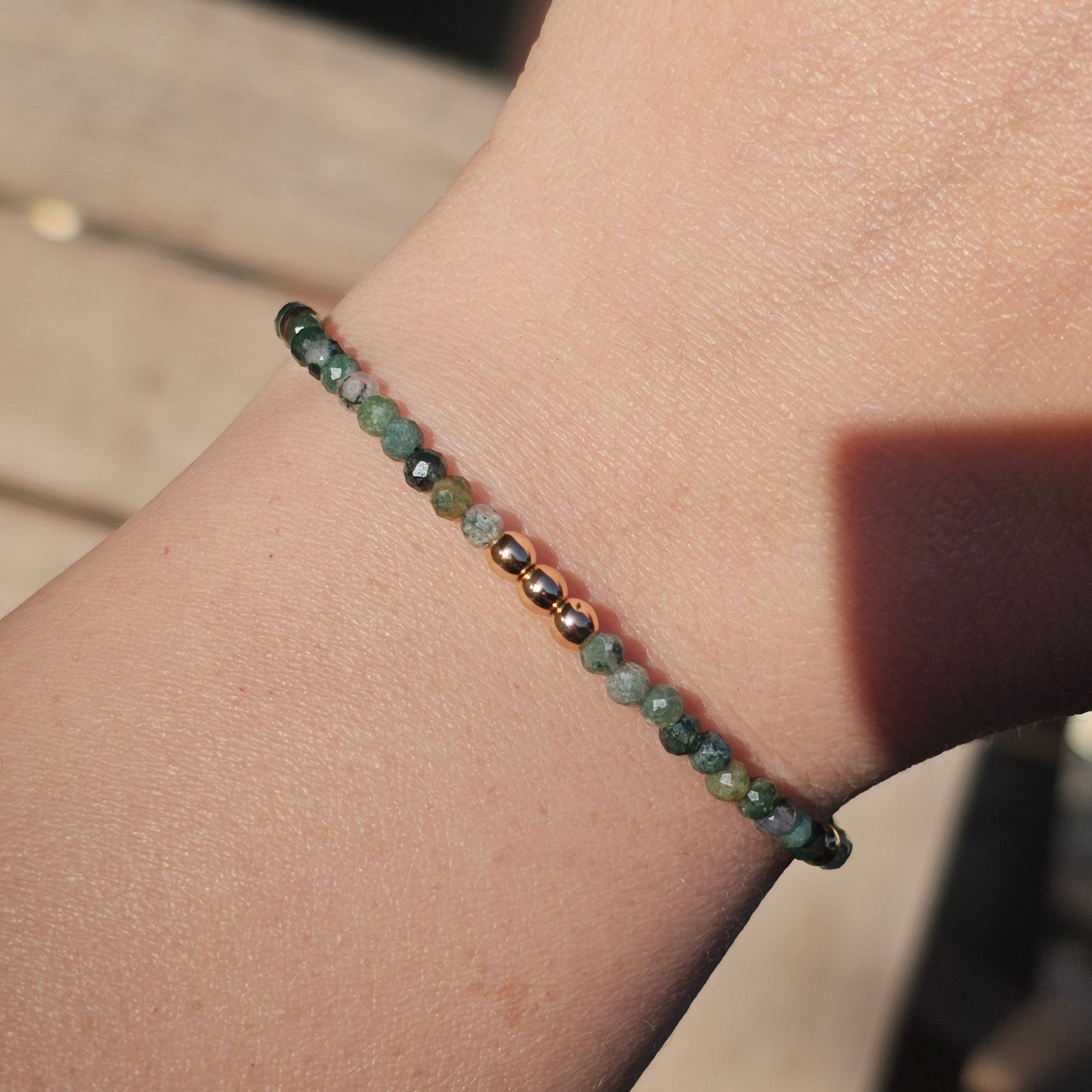 Delicate, faceted dainty Moss Agate and AAA grade gold plated Hematite bead bracelet with a gold stainless steel clasp and extender chain.