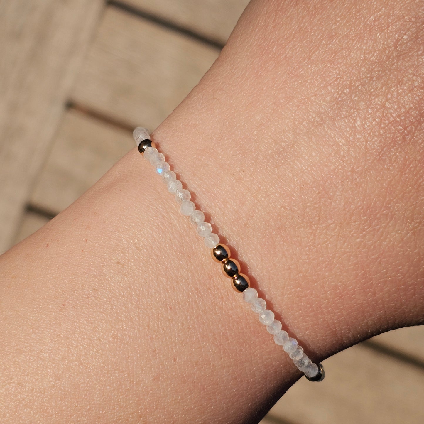 Delicate, faceted dainty AAA grade Rainbow Moonstone and AAA grade gold plated Hematite bead bracelet with a gold stainless steel clasp and extender chain.