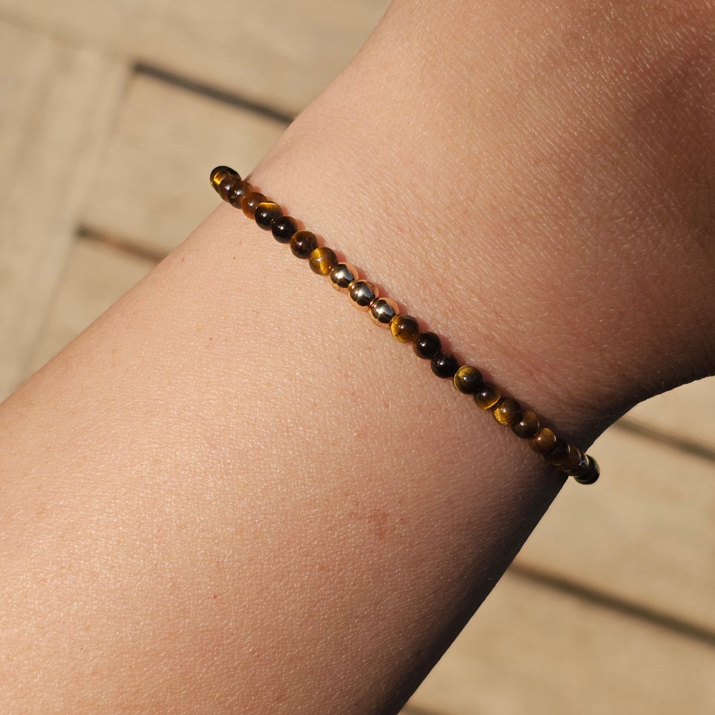 Delicate, round dainty AA Grade Tigers Eye and AAA grade gold plated Hematite bead bracelet with a gold stainless steel clasp and extender chain.