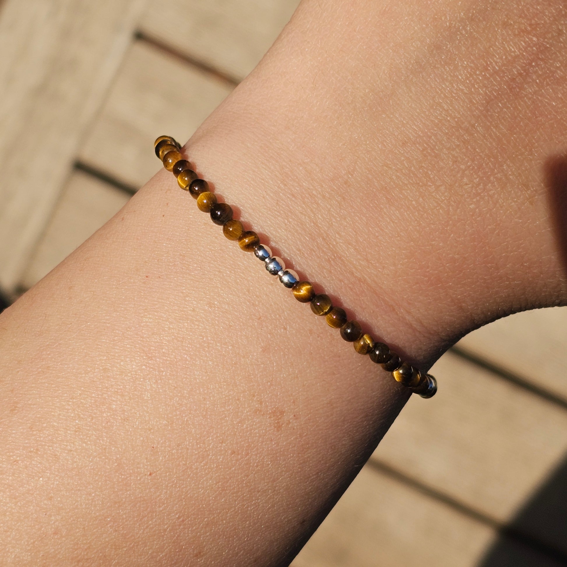 Delicate, round dainty AA Grade Tigers Eye and AAA grade silver plated Hematite bead bracelet with a silver stainless steel clasp and extender chain.