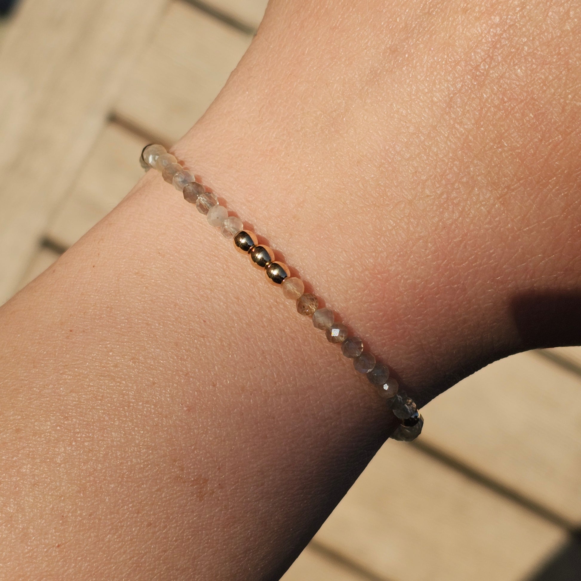 Delicate, faceted dainty Moonstone and AAA grade gold plated Hematite bead bracelet with a gold stainless steel clasp and extender chain.