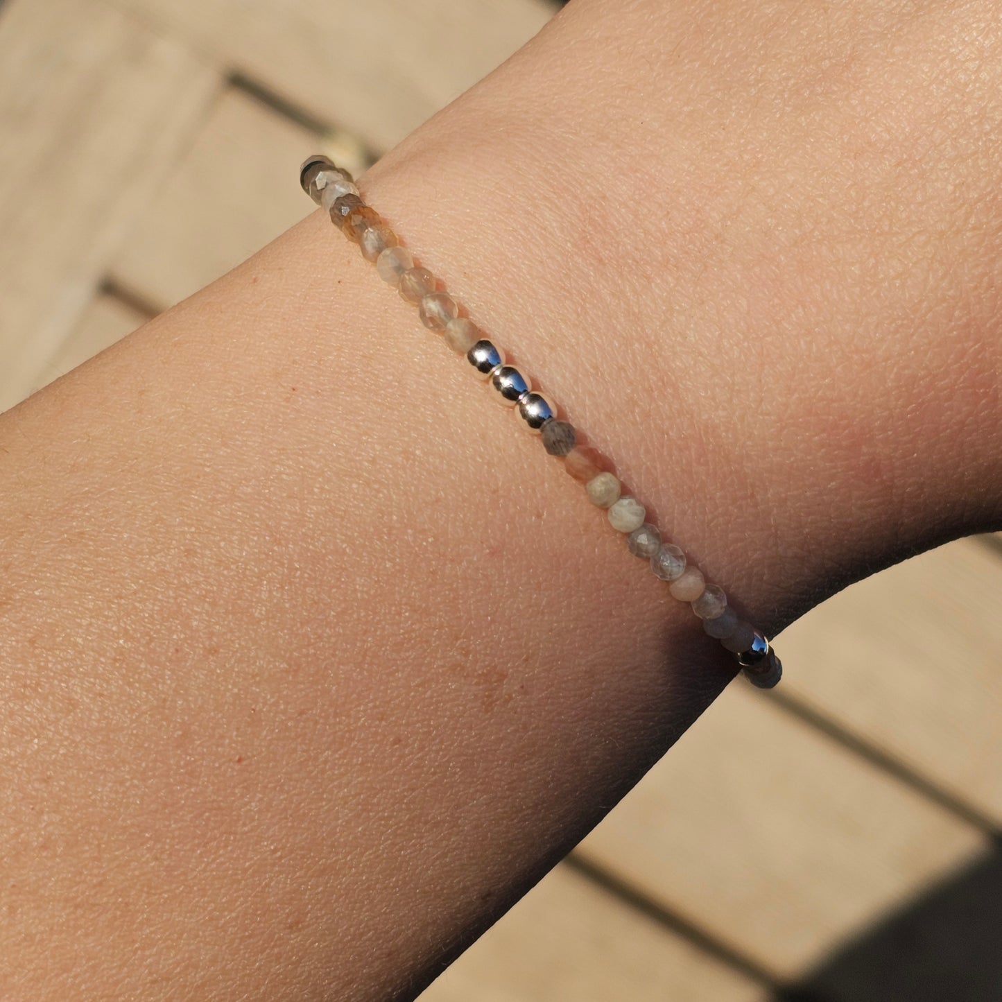 Delicate, faceted dainty Moonstone and AAA grade silver plated Hematite bead bracelet with a silver stainless steel clasp and extender chain.