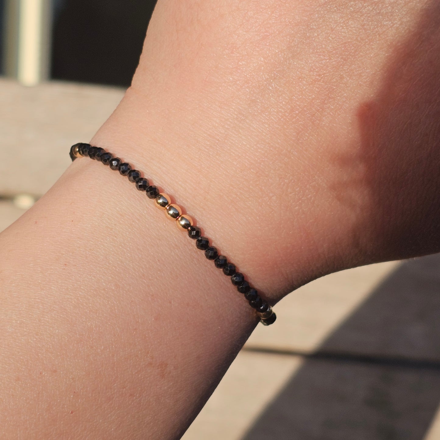 Delicate, faceted dainty Spinel and AAA grade gold plated Hematite bead bracelet with a gold stainless steel clasp and extender chain.