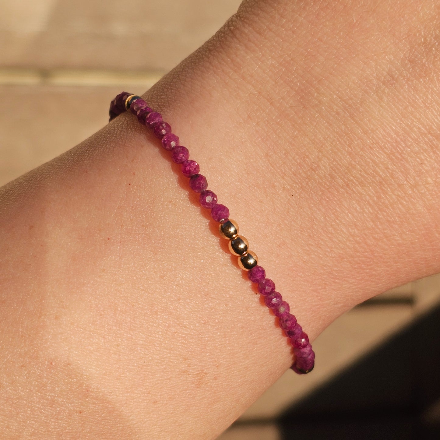 Delicate, faceted dainty Ruby and AAA grade gold plated Hematite bead bracelet with a gold stainless steel clasp and extender chain.