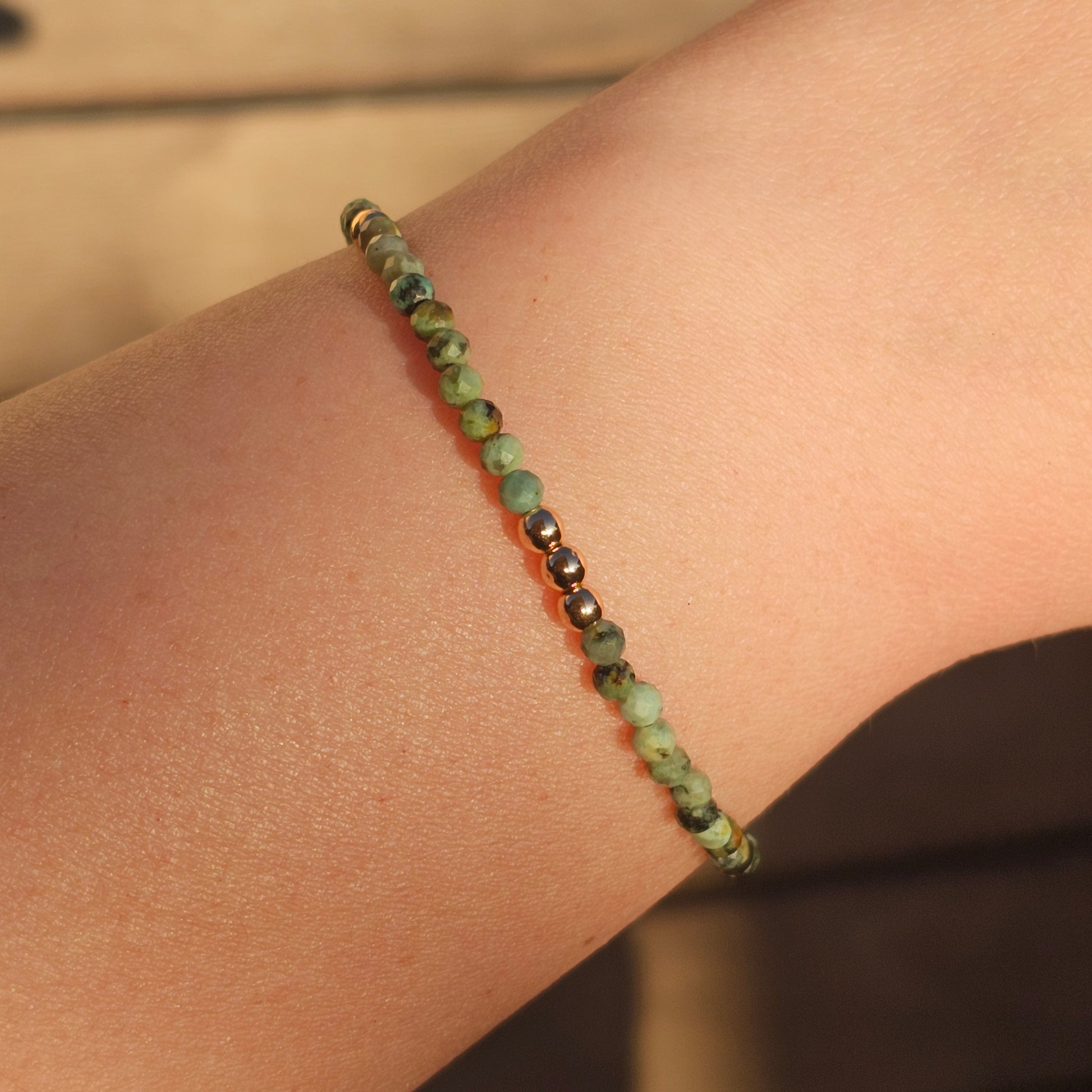 Delicate, faceted dainty African Turquoise and AAA grade gold plated Hematite bead bracelet with a gold stainless steel clasp and extender chain.