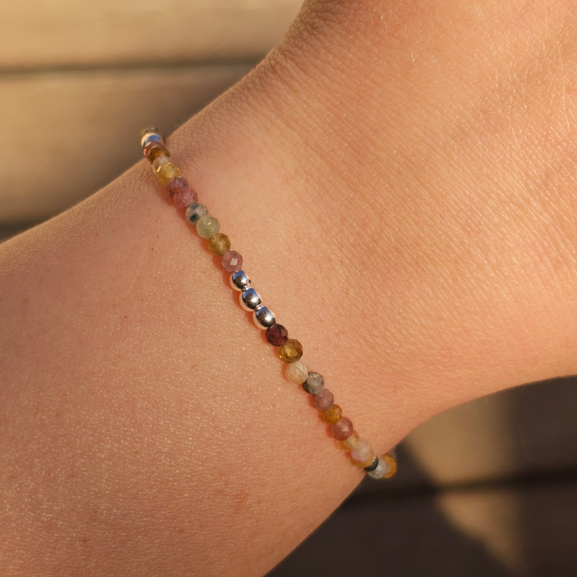 Delicate, faceted dainty AA grade colourful Tourmaline and AAA grade silver plated Hematite bead bracelet with a silver stainless steel clasp and extender chain.