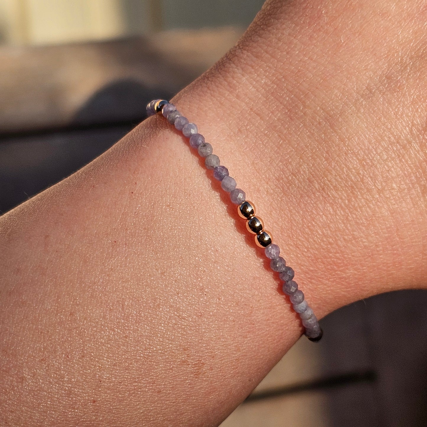 Delicate, faceted dainty Tanzanite and AAA grade gold plated Hematite bead bracelet with a gold stainless steel clasp and extender chain.