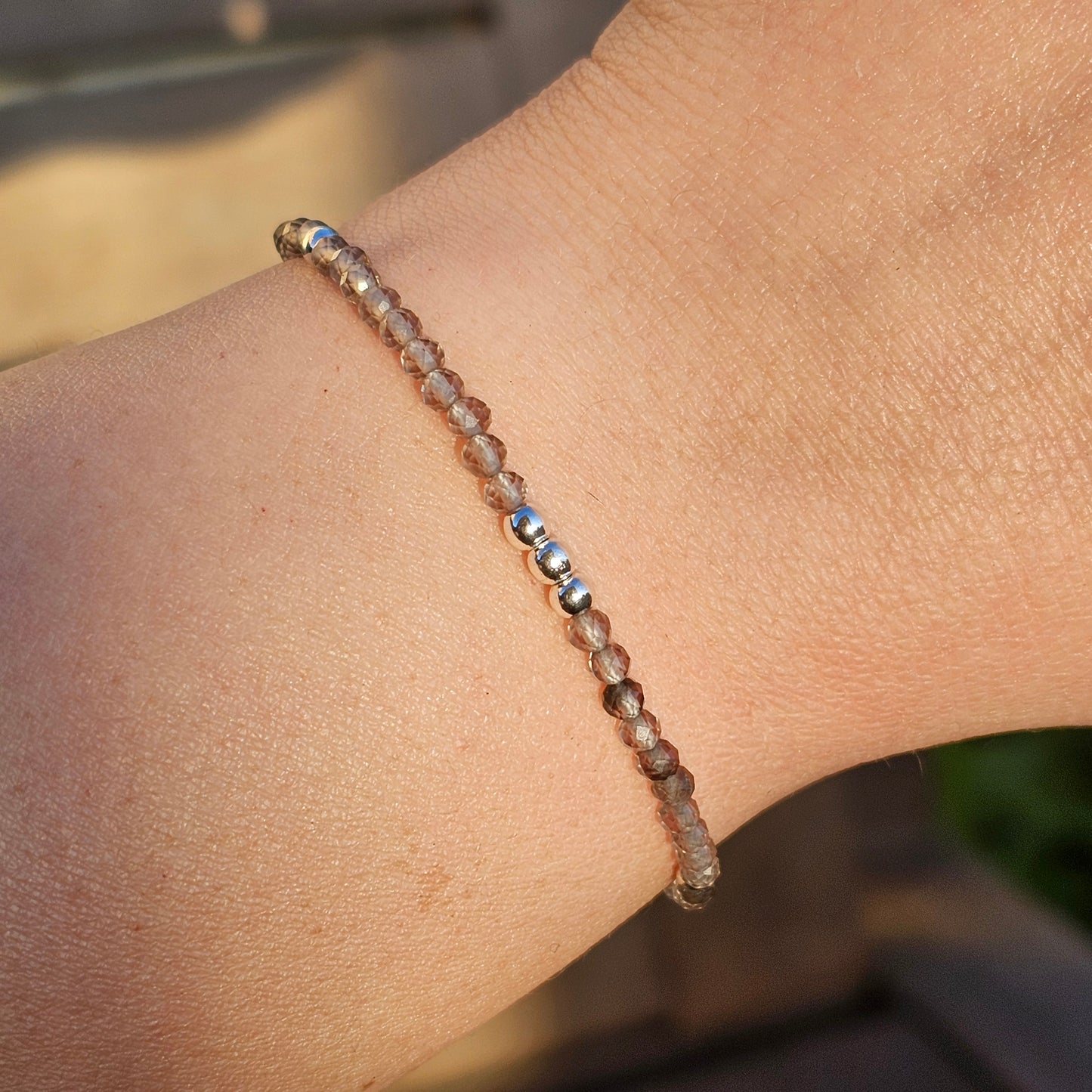 Delicate, faceted dainty Smoky Quartz and AAA grade silver plated Hematite bead bracelet with a silver stainless steel clasp and extender chain.