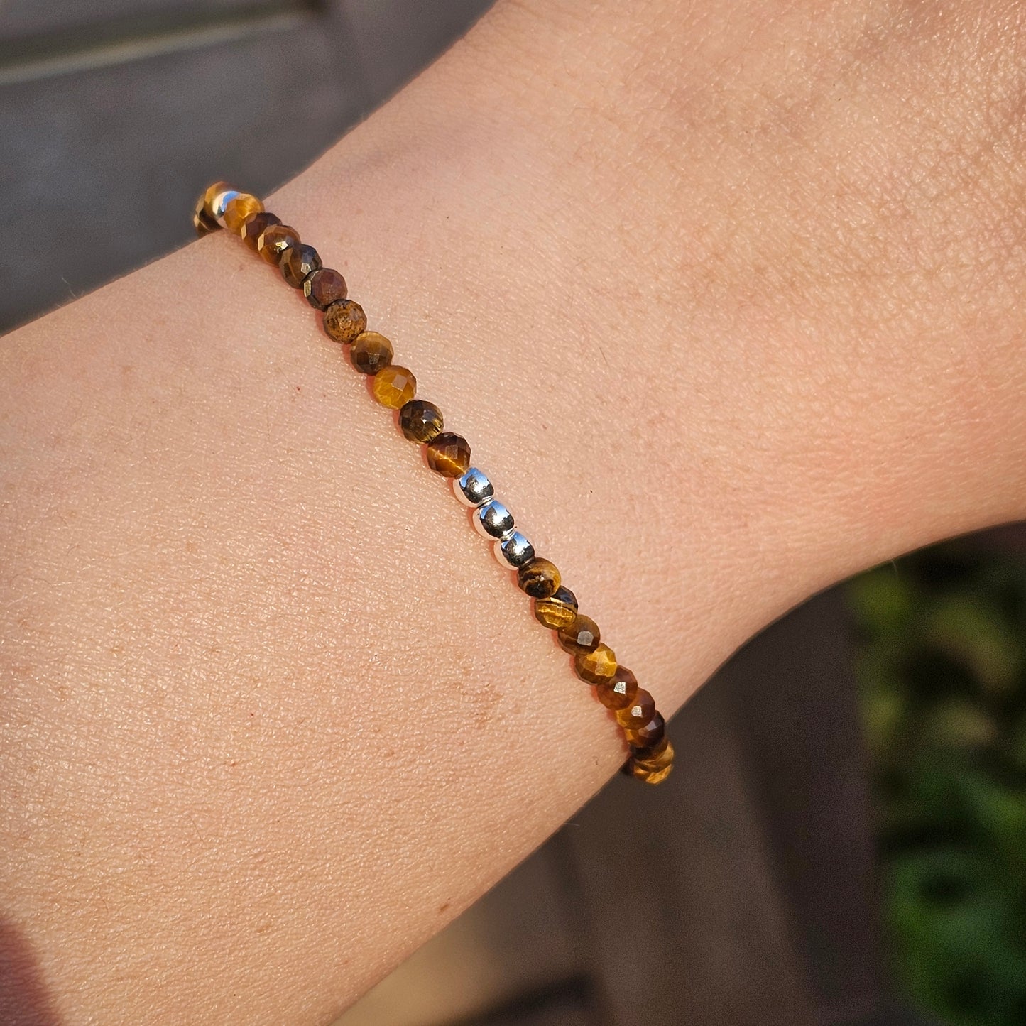 Delicate, faceted dainty Tiger's Eye and AAA grade silver plated Hematite bead bracelet with a silver stainless steel clasp and extender chain.