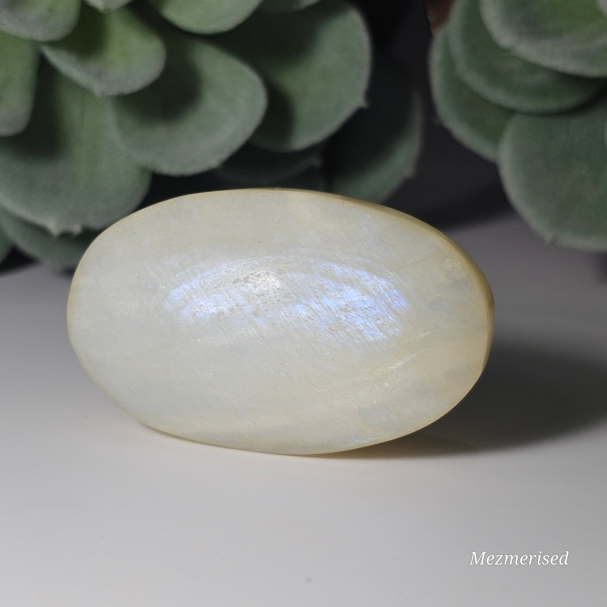 Medium sized Rainbow Moonstone palm stone with a beautiful blue flash.