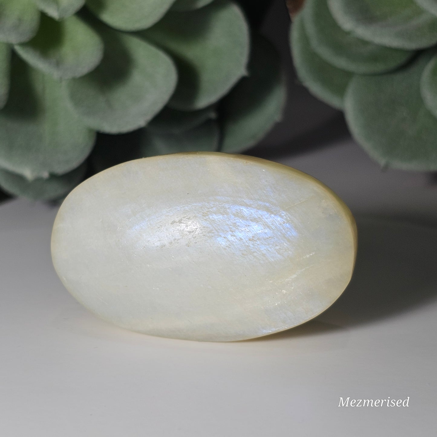 Medium sized Rainbow Moonstone palm stone with a beautiful blue flash.