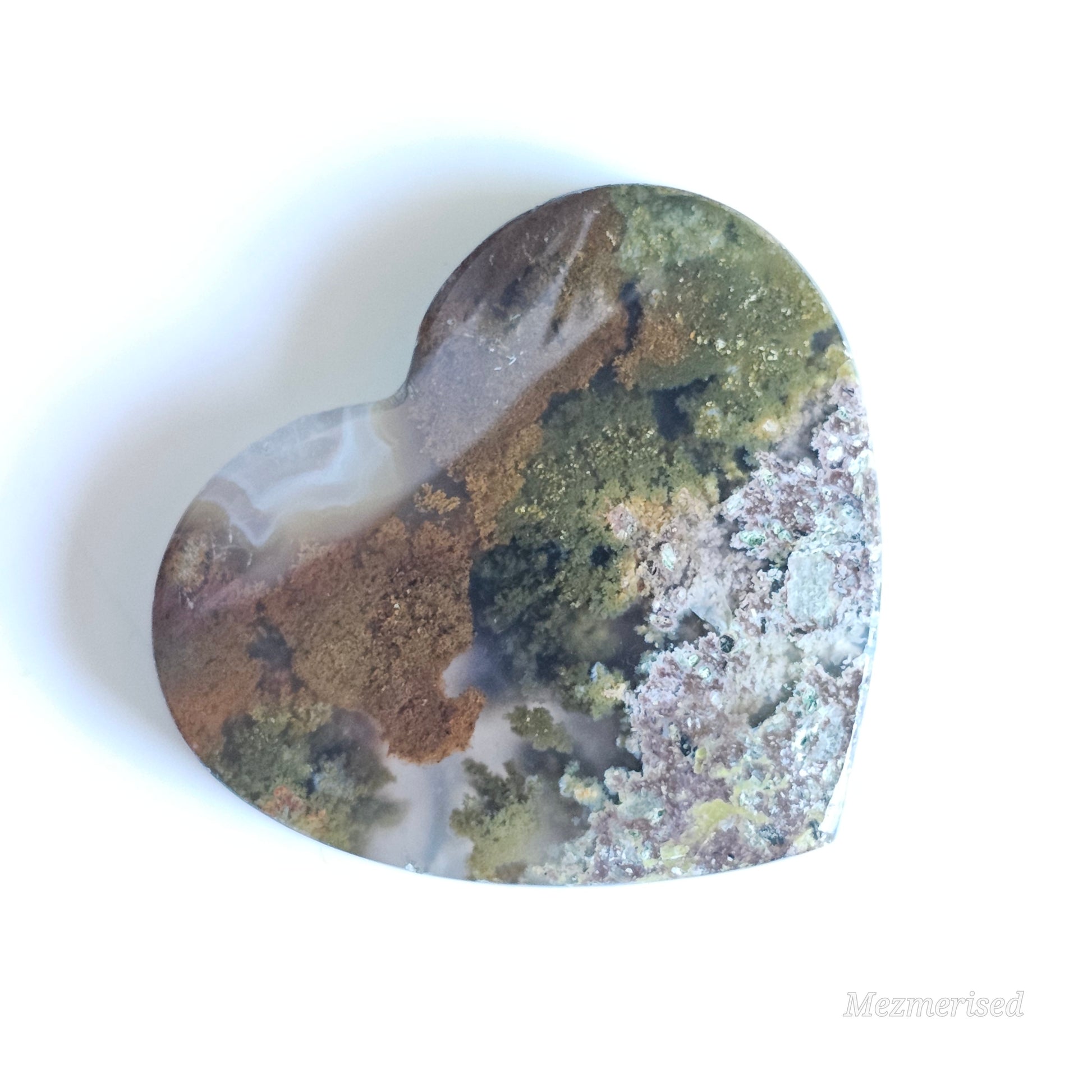 An exquisite heart carving, showcasing the alluring uniqueness of the Scenic Moss Agate which resembles nature's beautiful landscapes.