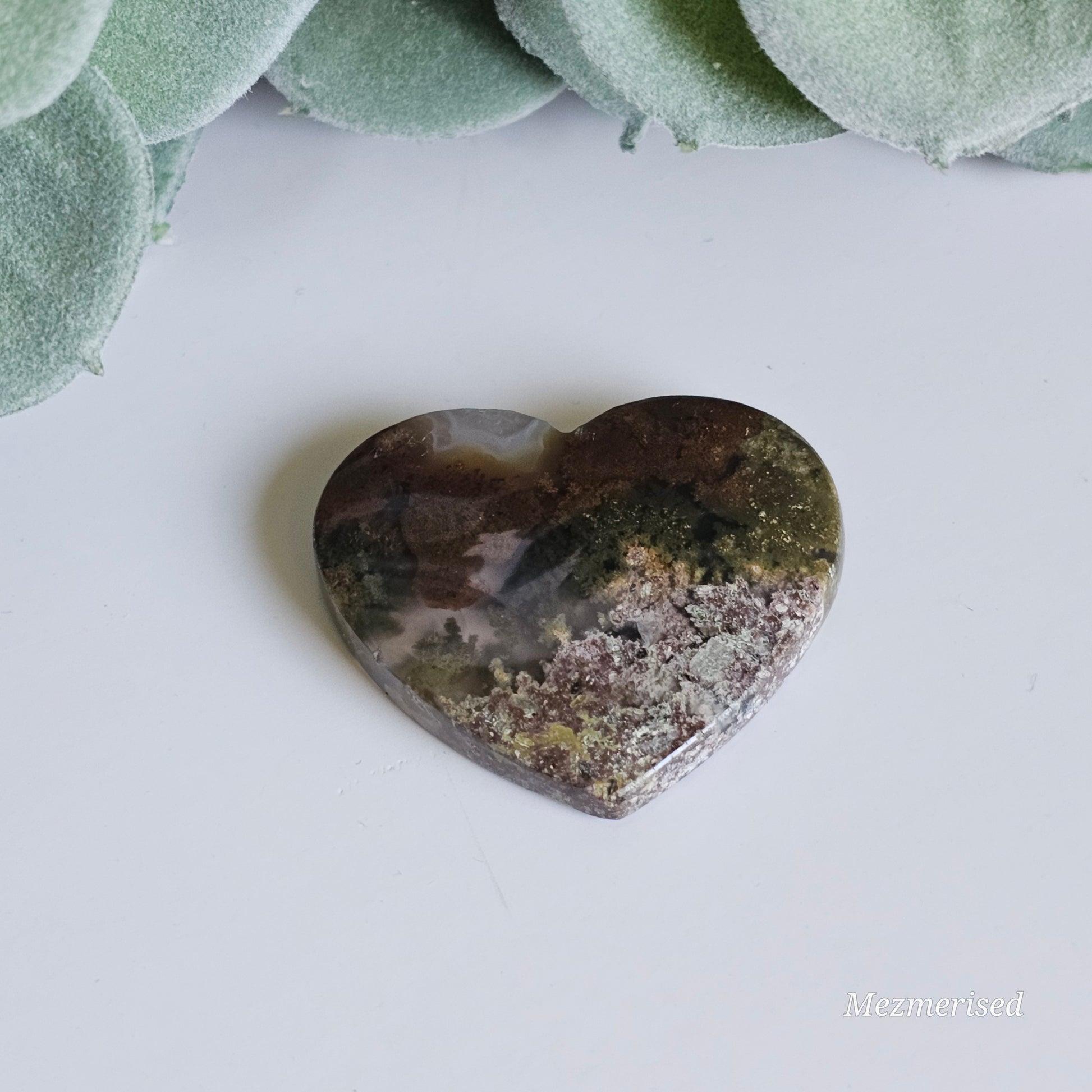 An exquisite heart carving, showcasing the alluring uniqueness of the Scenic Moss Agate which resembles nature's beautiful landscapes.