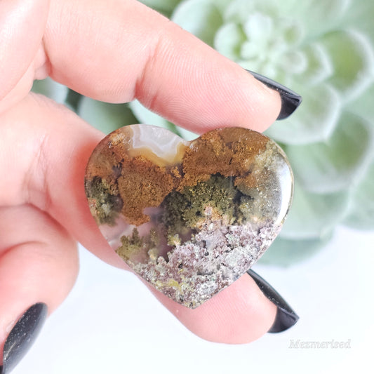 An exquisite heart carving, showcasing the alluring uniqueness of the Scenic Moss Agate which resembles nature's beautiful landscapes.