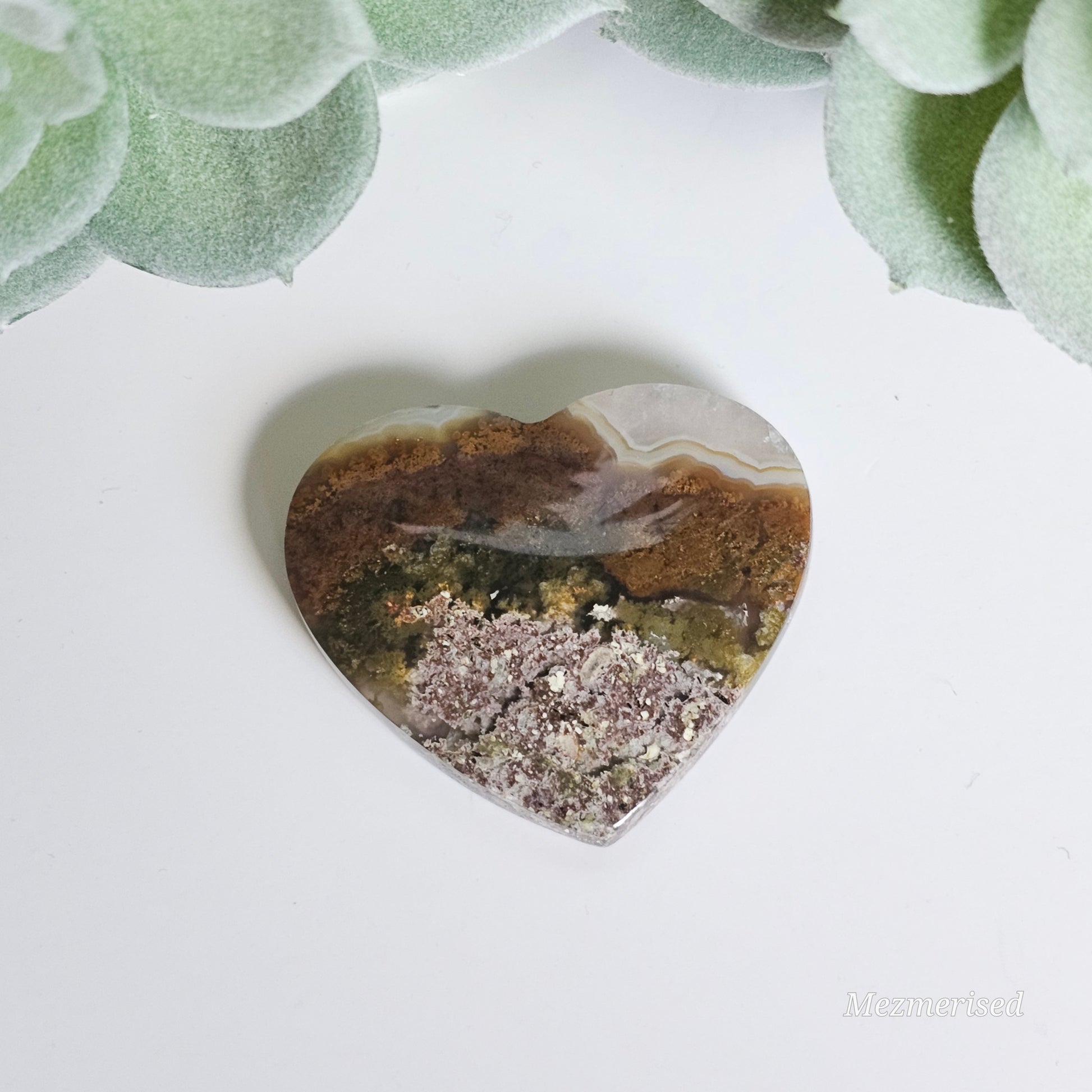 An exquisite heart carving, showcasing the alluring uniqueness of the Scenic Moss Agate which resembles nature's beautiful landscapes.