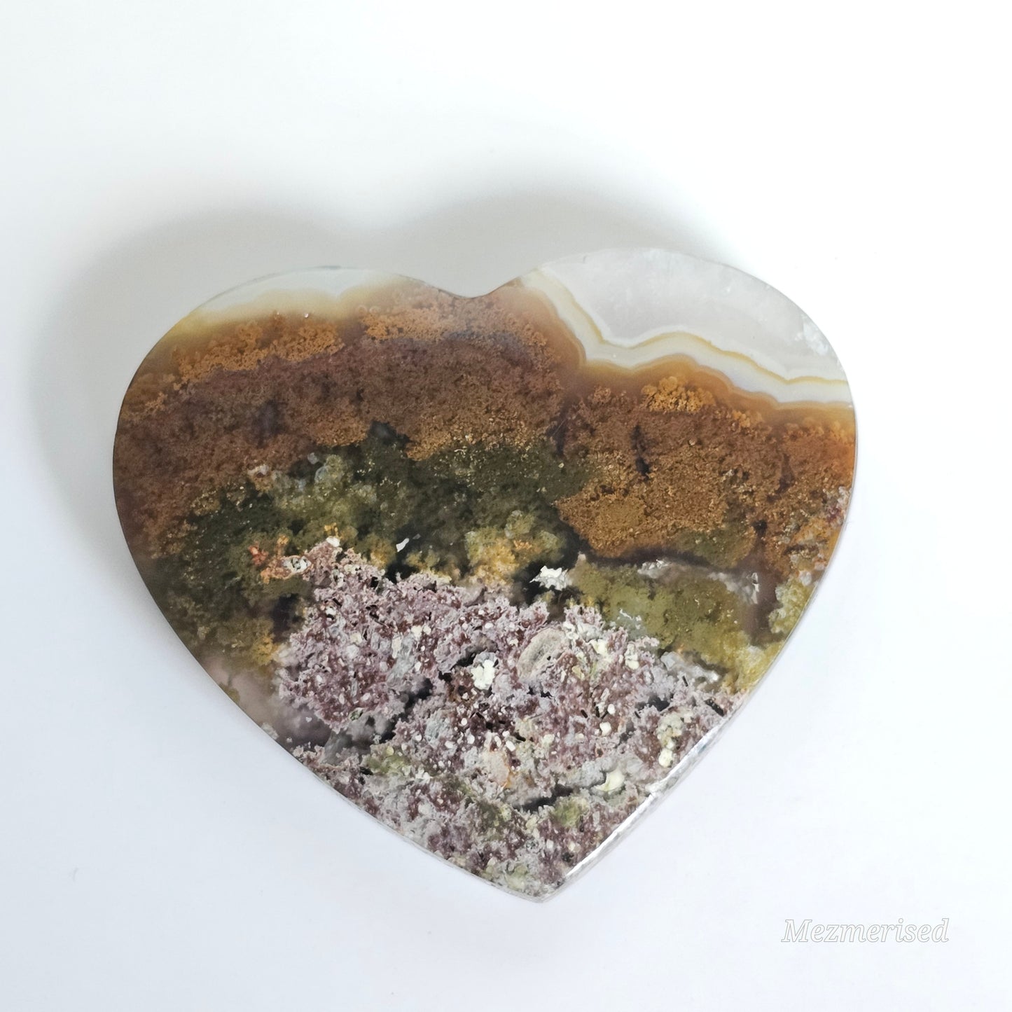 An exquisite heart carving, showcasing the alluring uniqueness of the Scenic Moss Agate which resembles nature's beautiful landscapes.