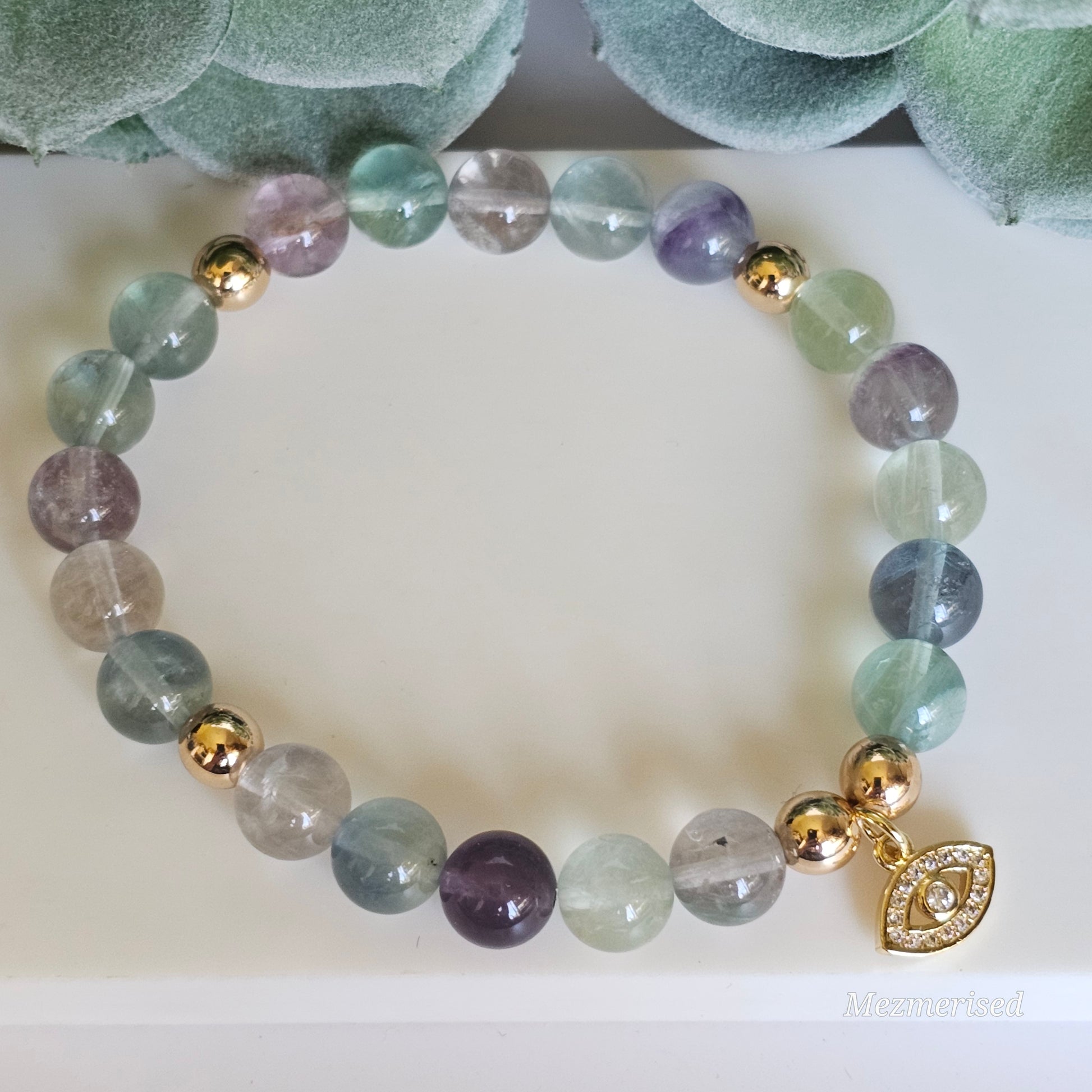 8mm A grade rainbow Fluorite and gold plated Hematite bead stretch bracelet with your choice of charm.