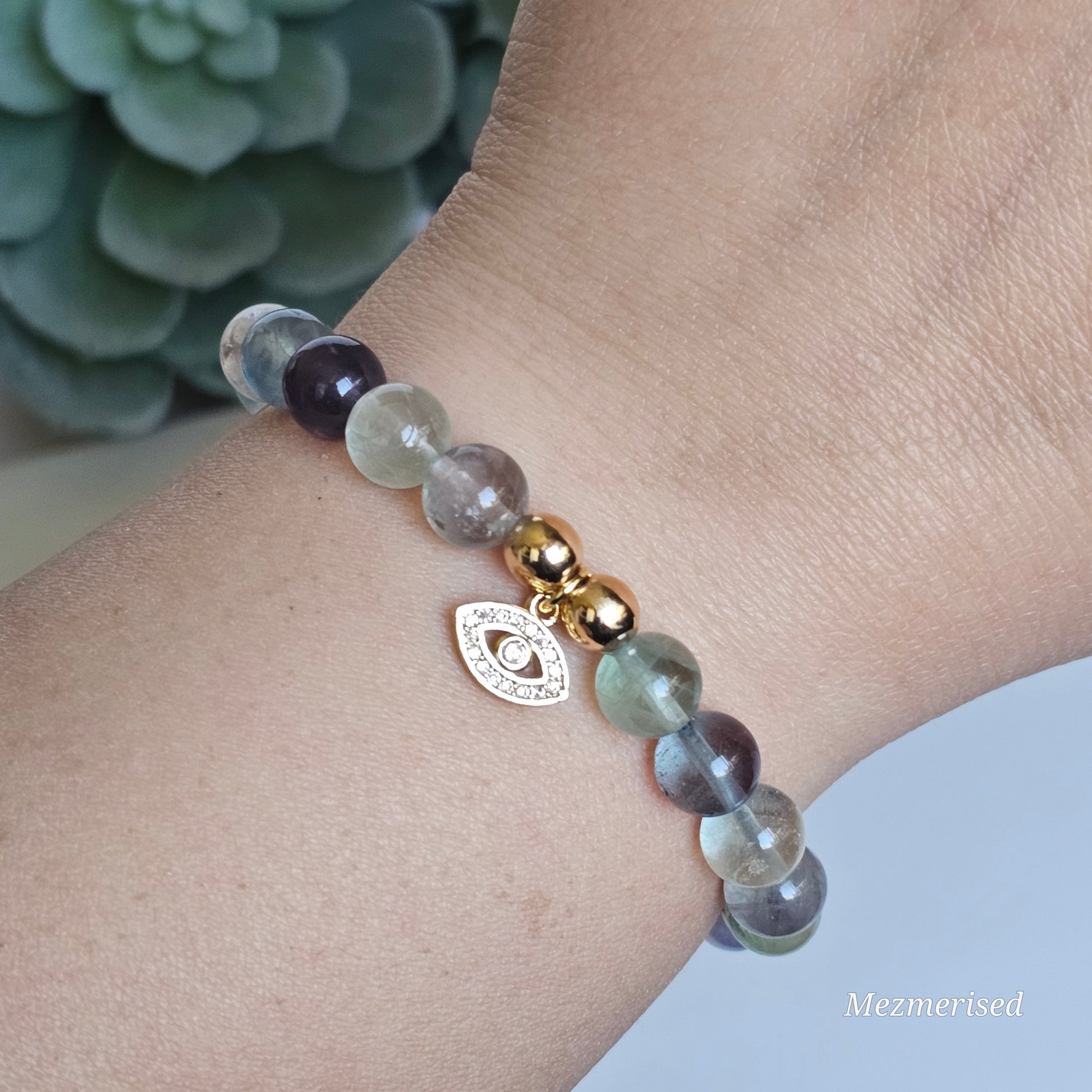 8mm A grade rainbow Fluorite and gold plated Hematite bead stretch bracelet with your choice of charm.