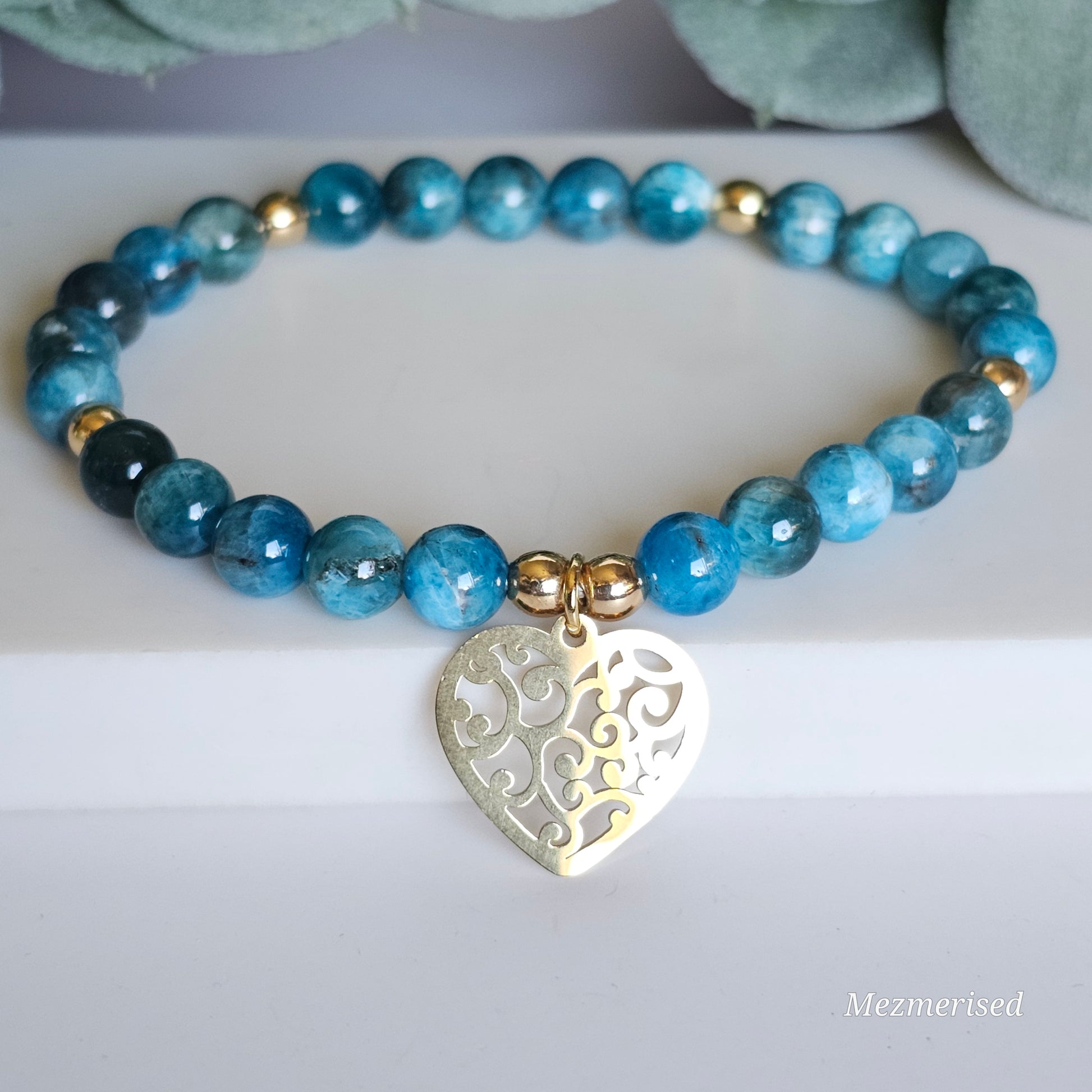 6mm A grade blue Apatite and gold plated Hematite bead stretch bracelet with your choice of charm.