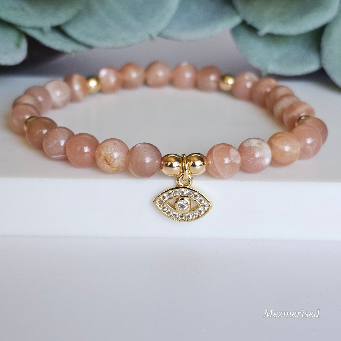 6mm AA grade Sunstone and gold plated Hematite bead stretch bracelet with your choice of charm.