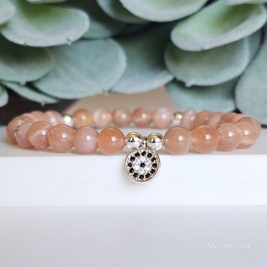 6mm AA grade Sunstone and silver plated Hematite bead stretch bracelet with your choice of charm.