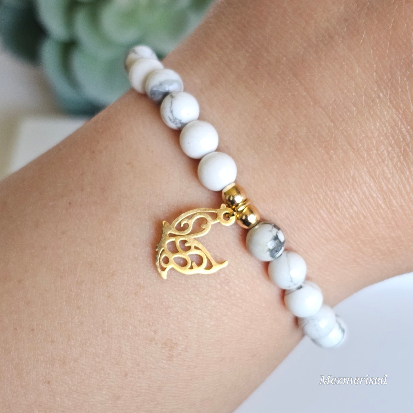 6mm Howlite and gold plated Hematite bead stretch bracelet with your choice of charm.