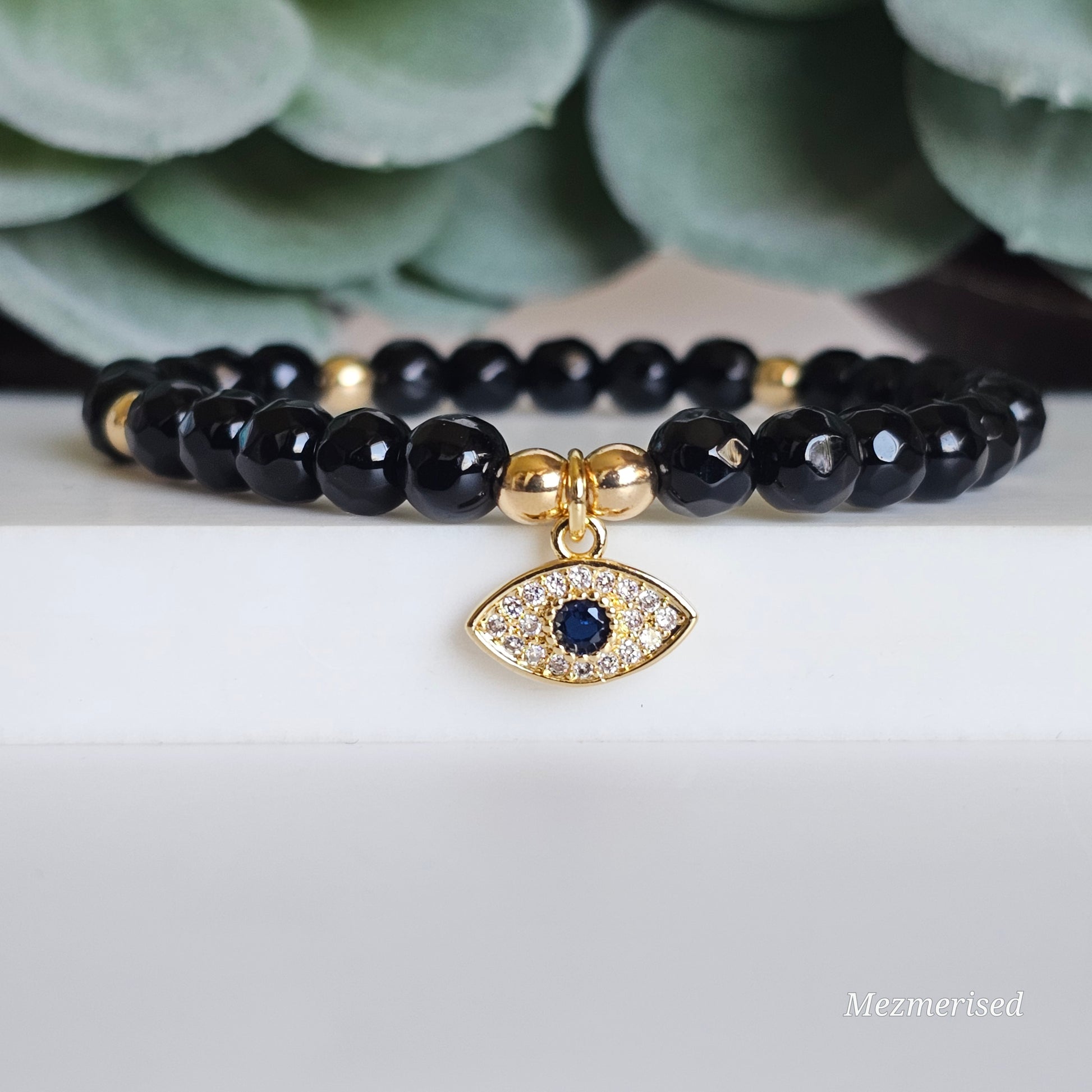 6mm faceted Onyx and gold plated Hematite bead stretch bracelet with your choice of charm.