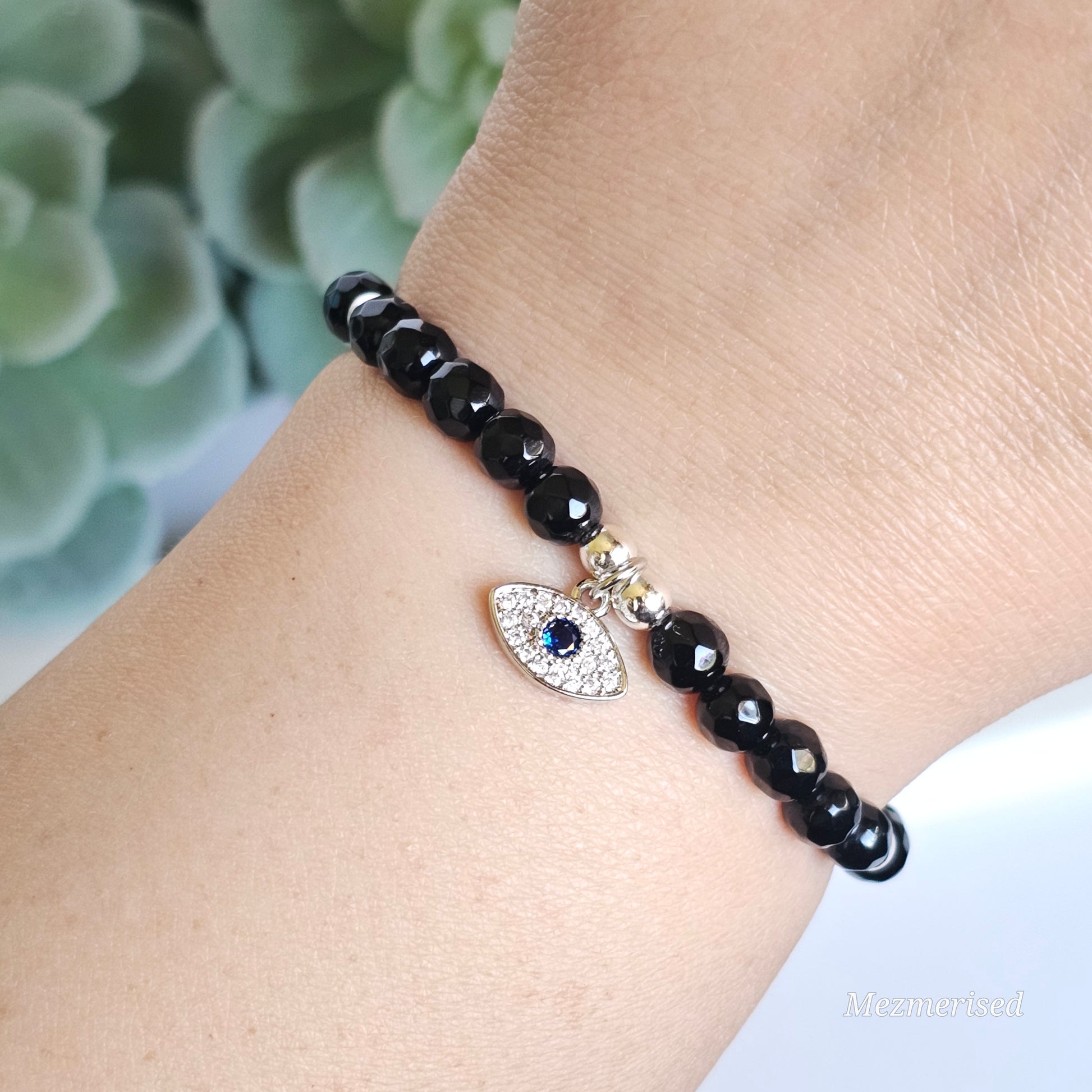 6mm faceted Onyx and silver plated Hematite bead stretch bracelet with your choice of charm.