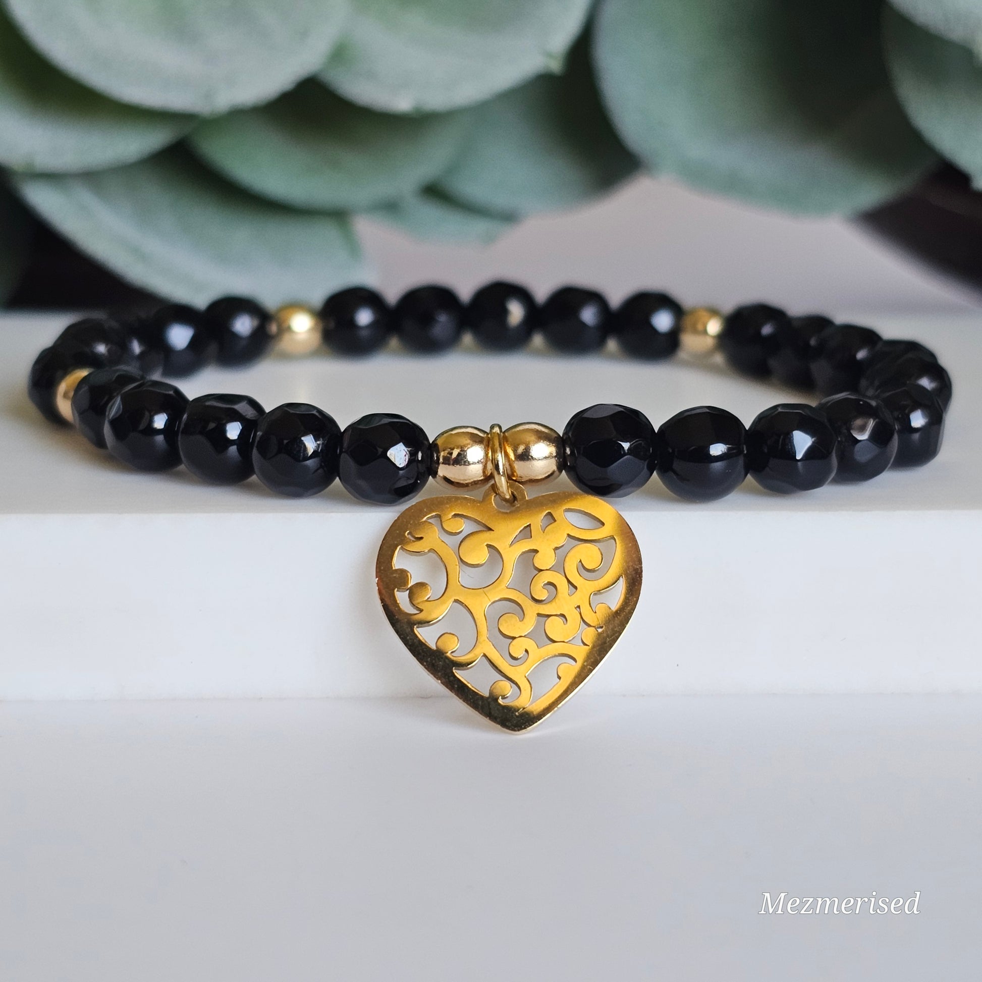 6mm faceted Onyx and gold plated Hematite bead stretch bracelet with your choice of charm.