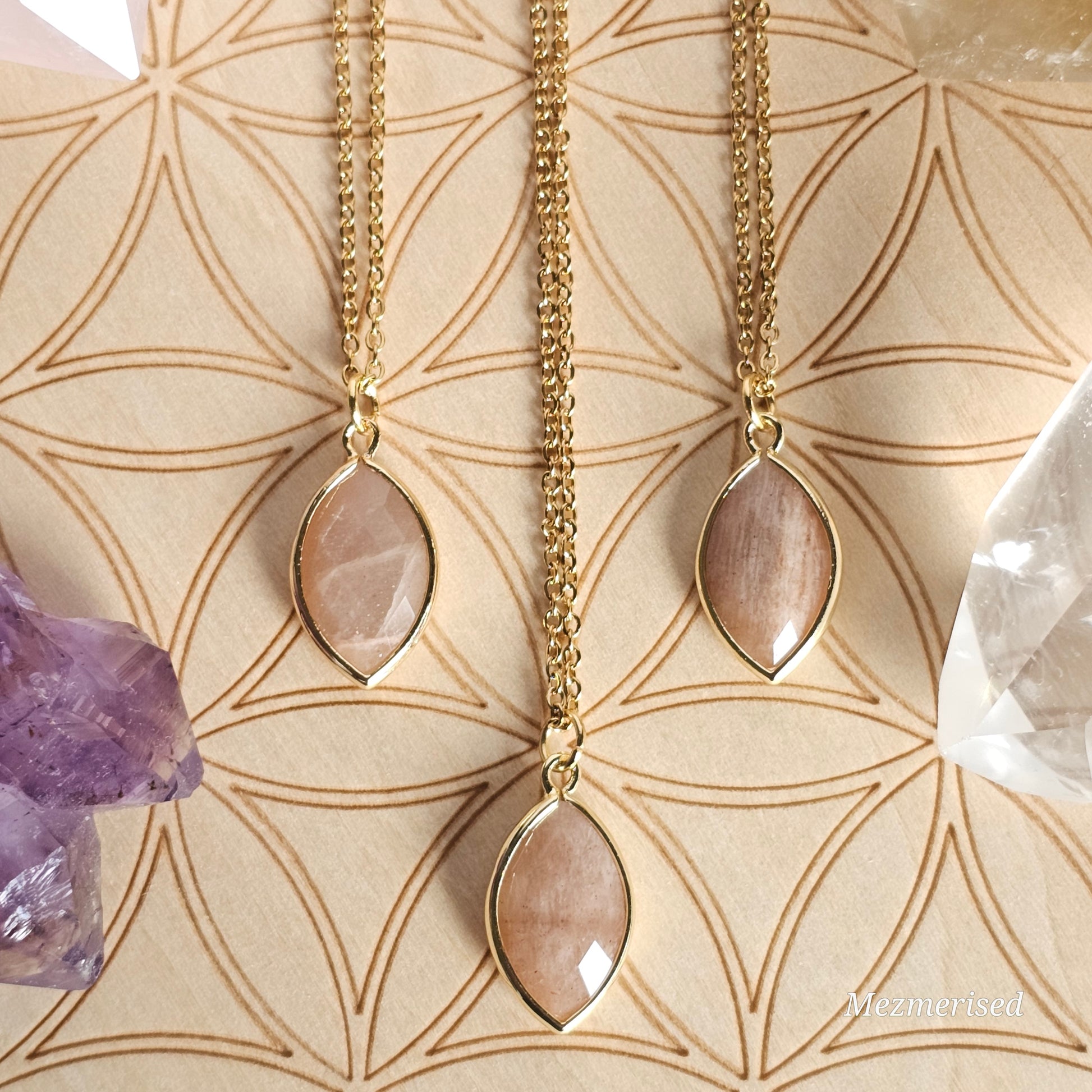 Faceted Sunstone marquise pendant suspended from a gold coloured stainless steel chain.