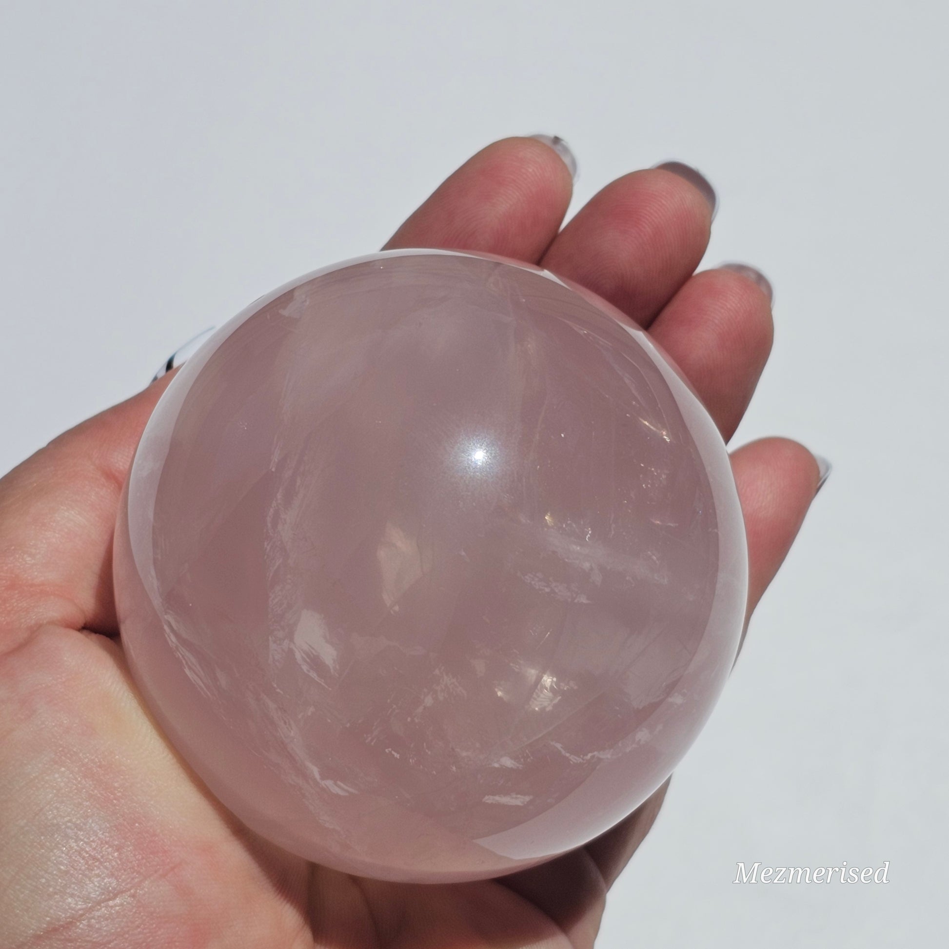 A beautiful Rose Quartz sphere with flash and gorgeous rainbows