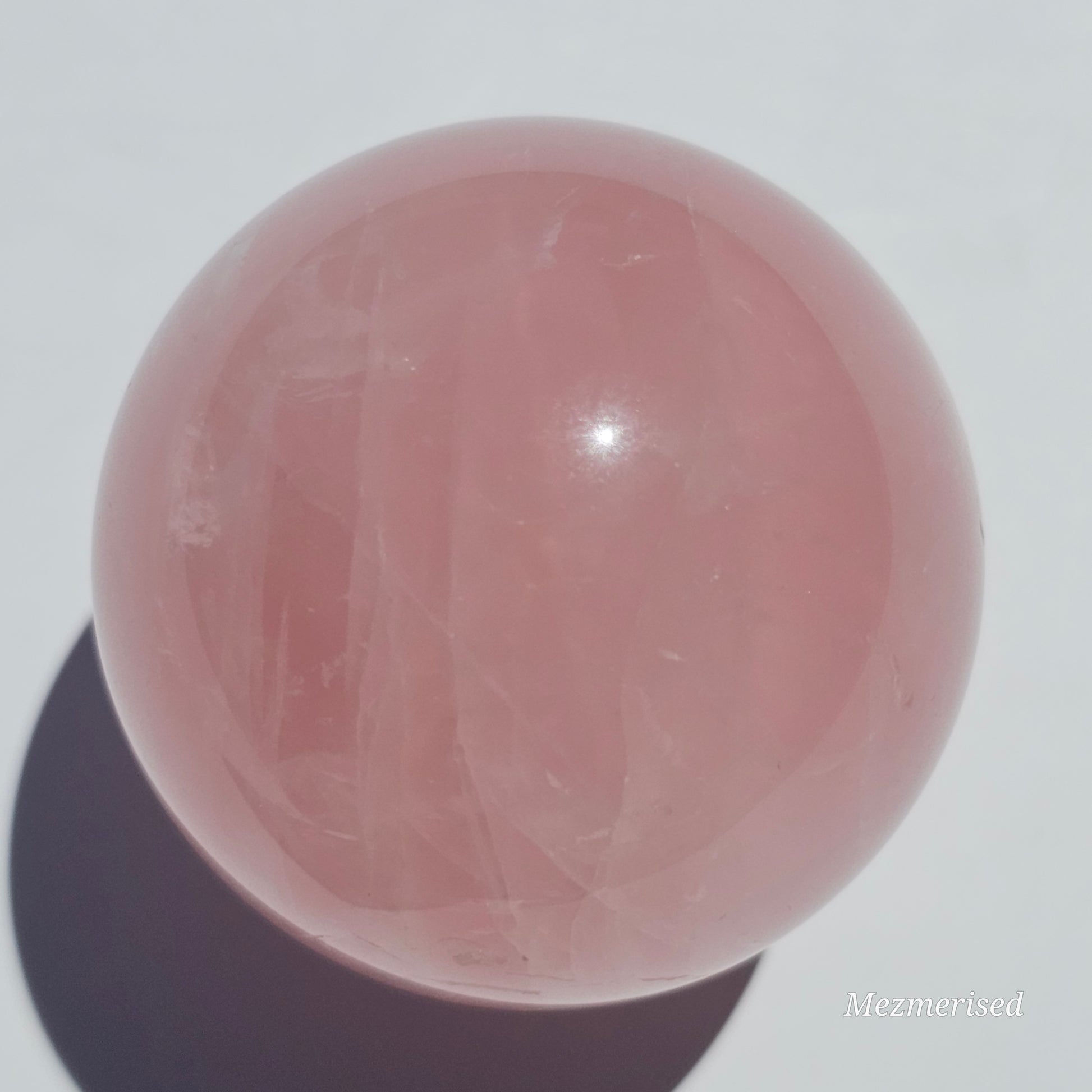 A beautiful Rose Quartz sphere with asterism and gorgeous rainbows